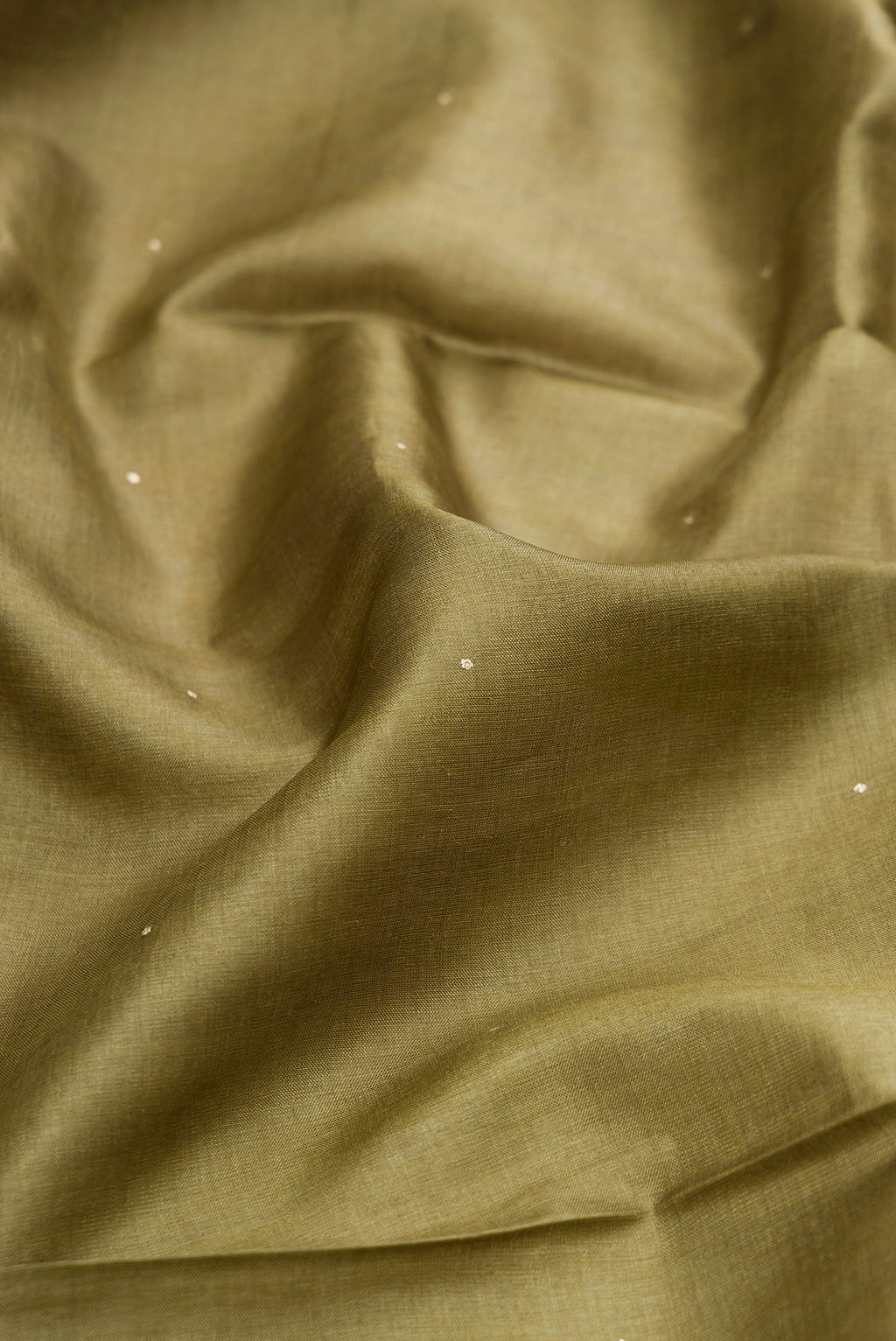 Close up of Mehandi Green Dual Tone Tussar Silk Saree with Embroidery on the body and Embroidery Border.  displaying folds