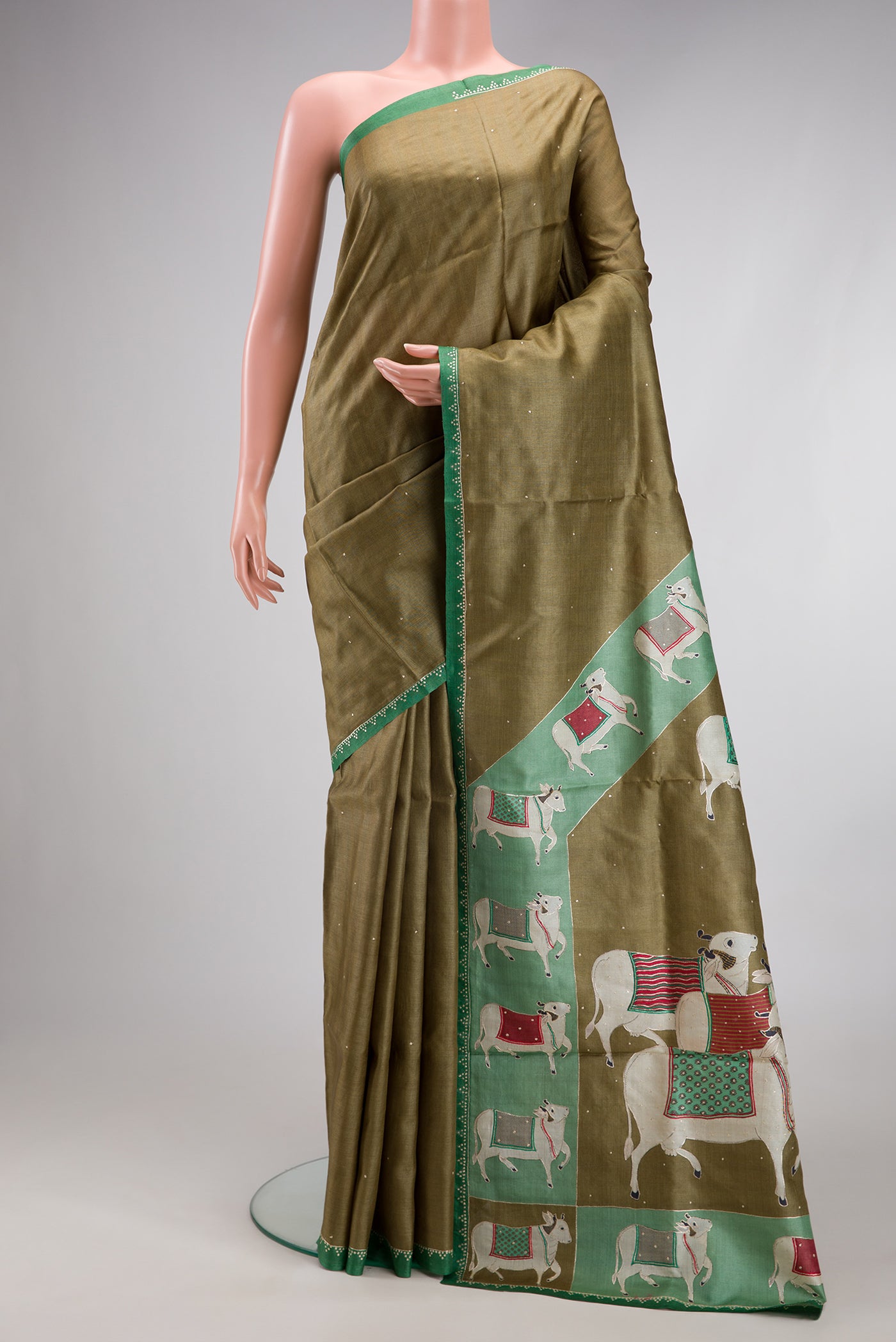 Mehandi Green Dual Tone Tussar Silk Saree with Embroidery on the body and Embroidery Border.  displayed on a mannequin