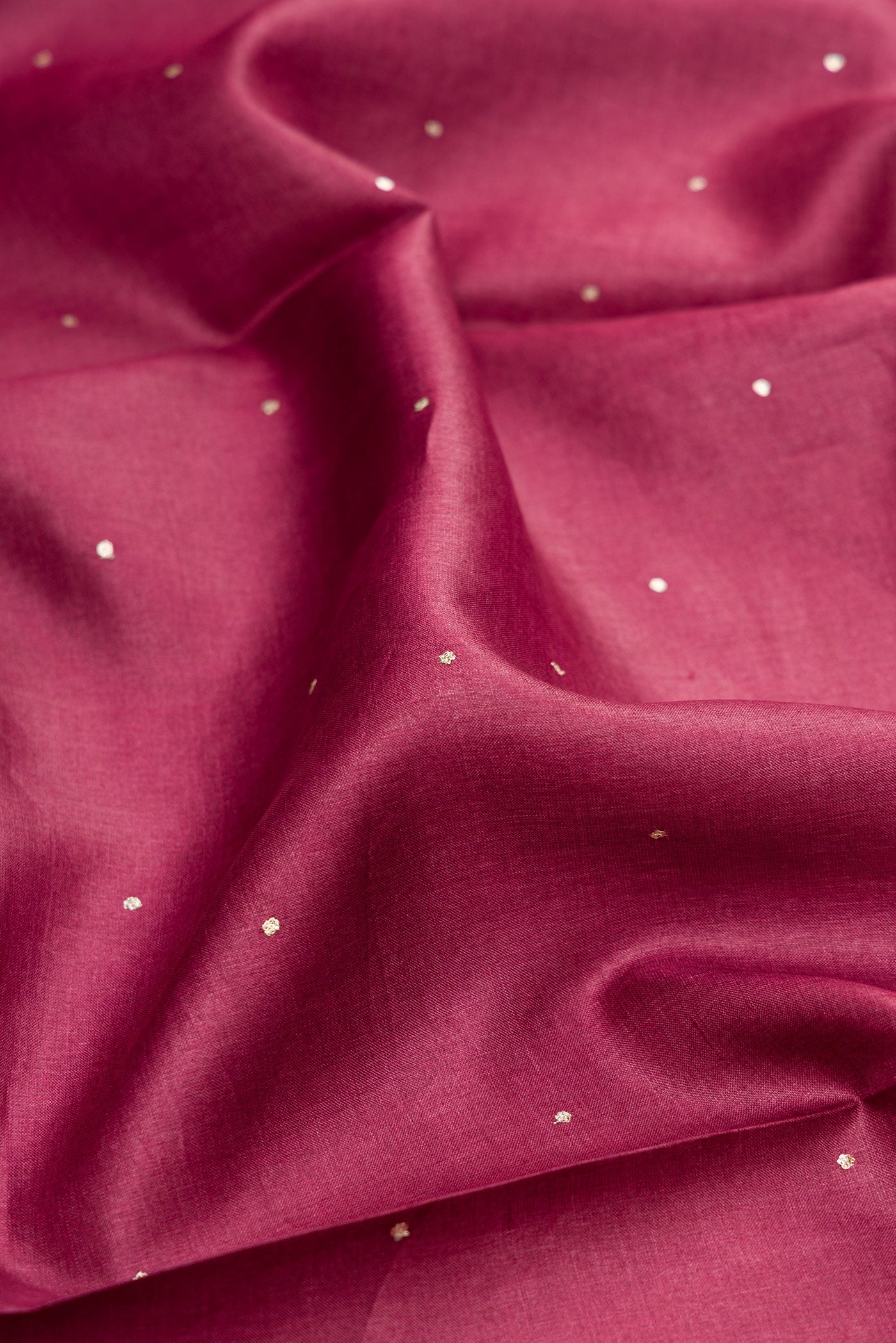 Close up of Magenta Dual Tone Tussar Silk Saree with Embroidery on the body and Embroidery Border.  displaying folds