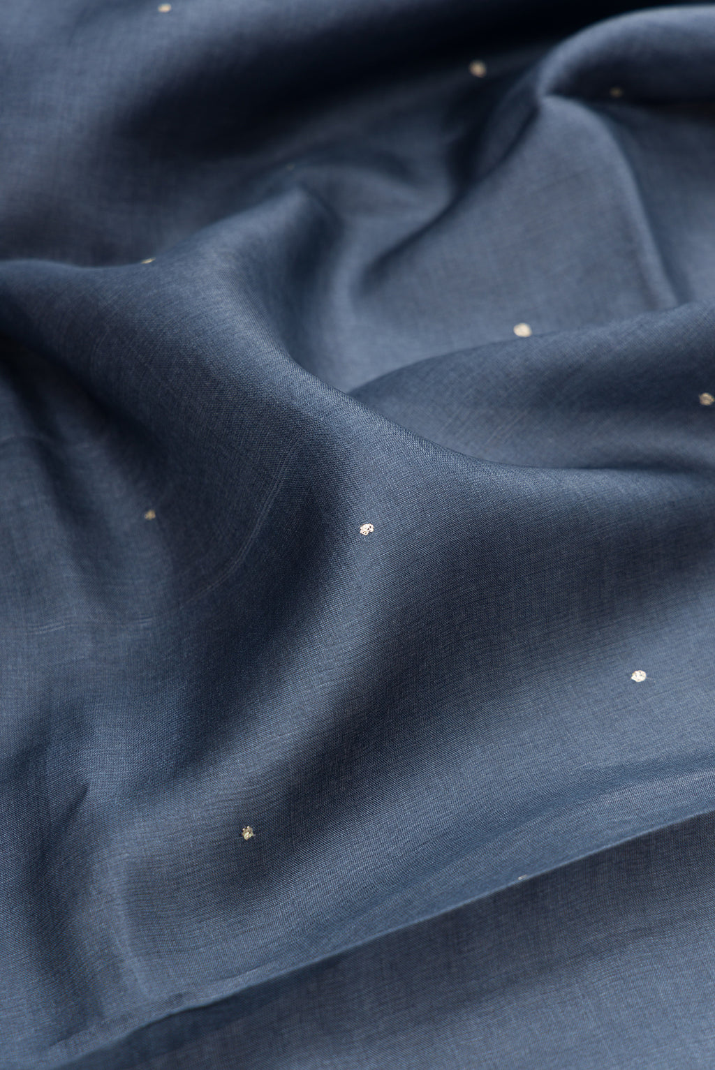 Close up of Grey Tussar Silk Saree with Embroidery on the body and Embroidery Border.  displaying folds
