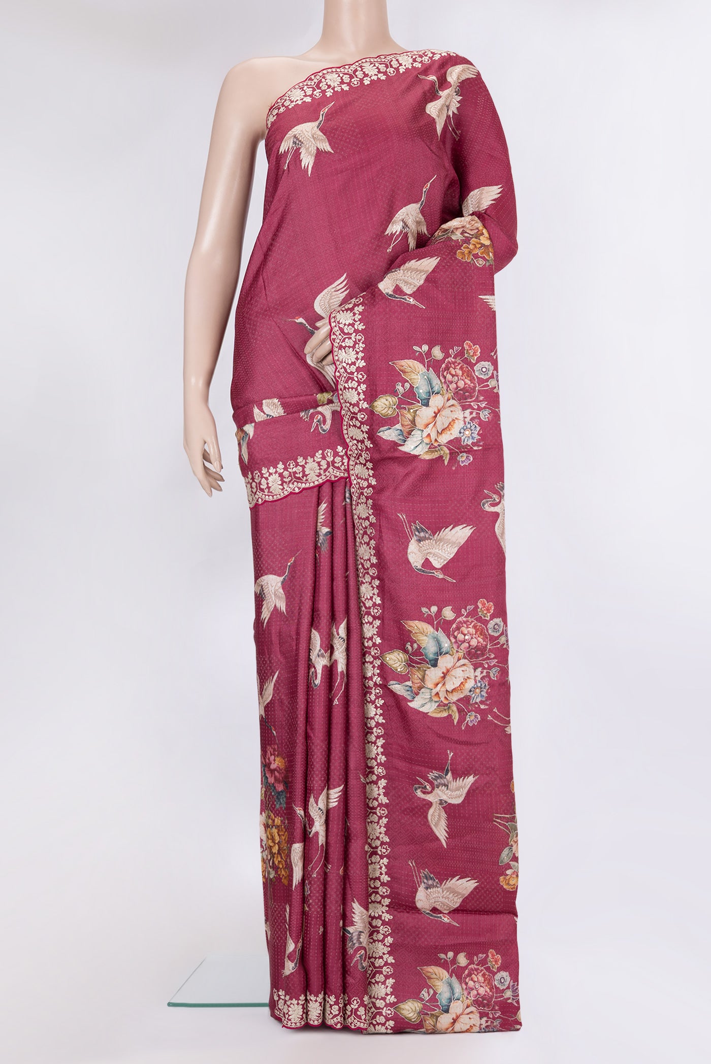 Maroon Tussar Silk Saree with Embroidery on the body and Embroidery Border.  displayed on a mannequin