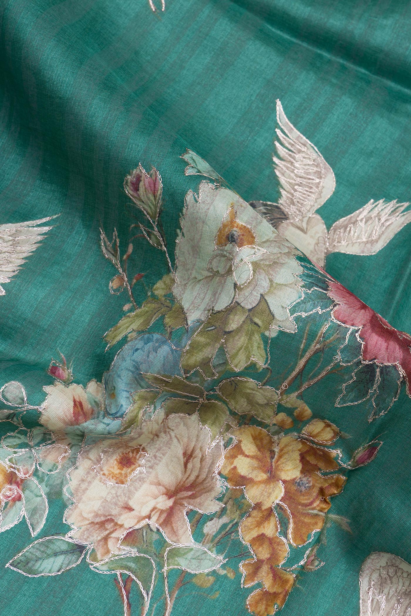 Close up of Green Tussar Silk Saree with Embroidery on the body and Embroidery Border.  displaying folds