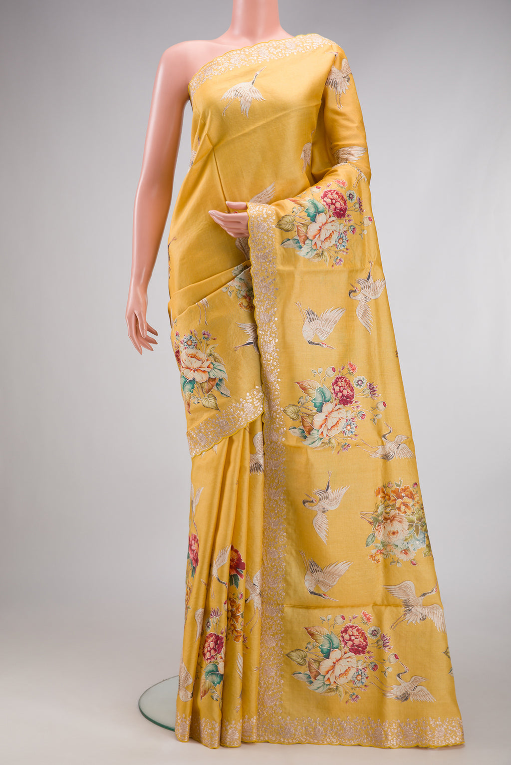 Yellow Tussar Silk Saree with Embroidery on the body and Fancy Border.  displayed on a mannequin