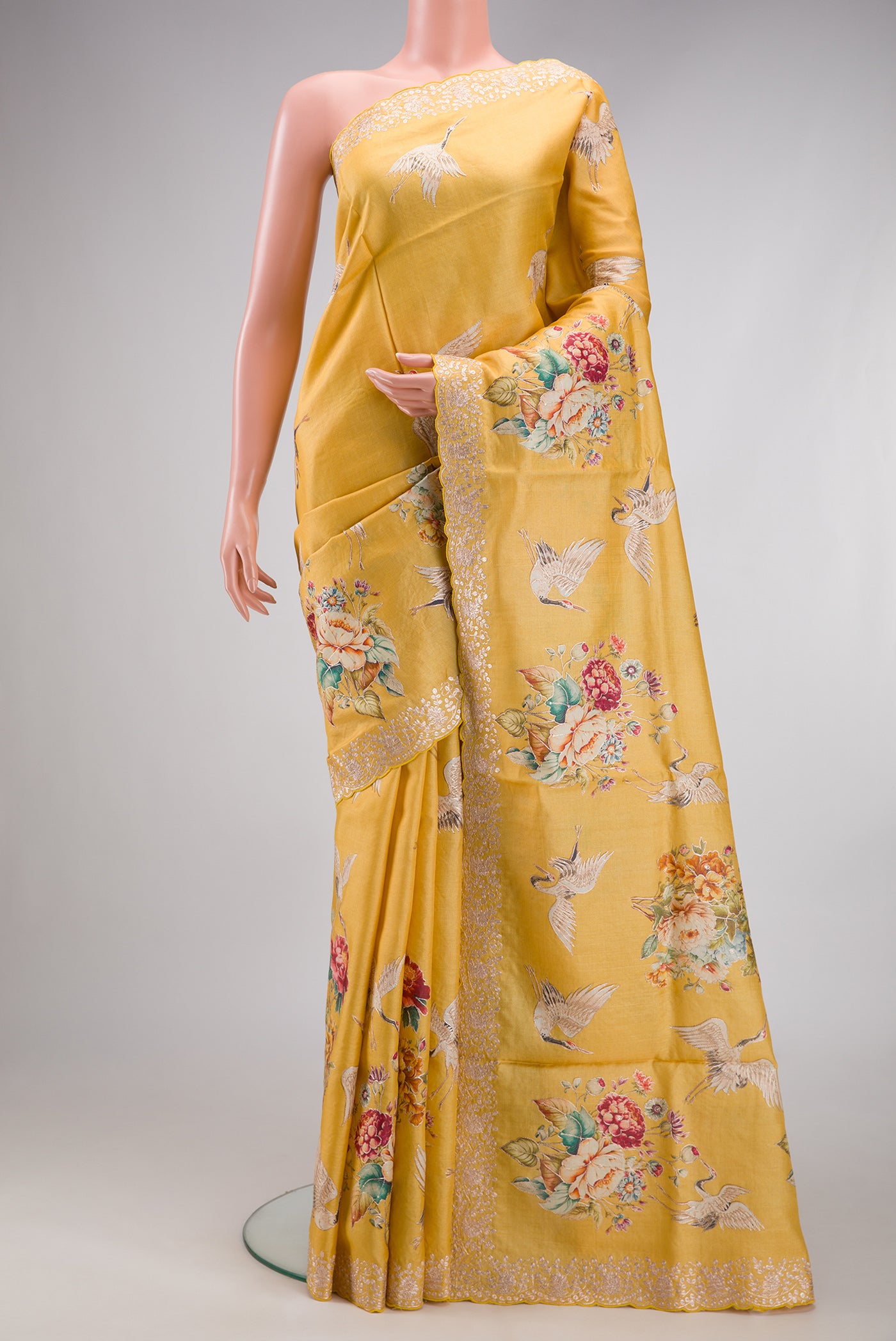 Yellow Tussar Silk Saree with Embroidery on the body and Fancy Border.  displayed on a mannequin