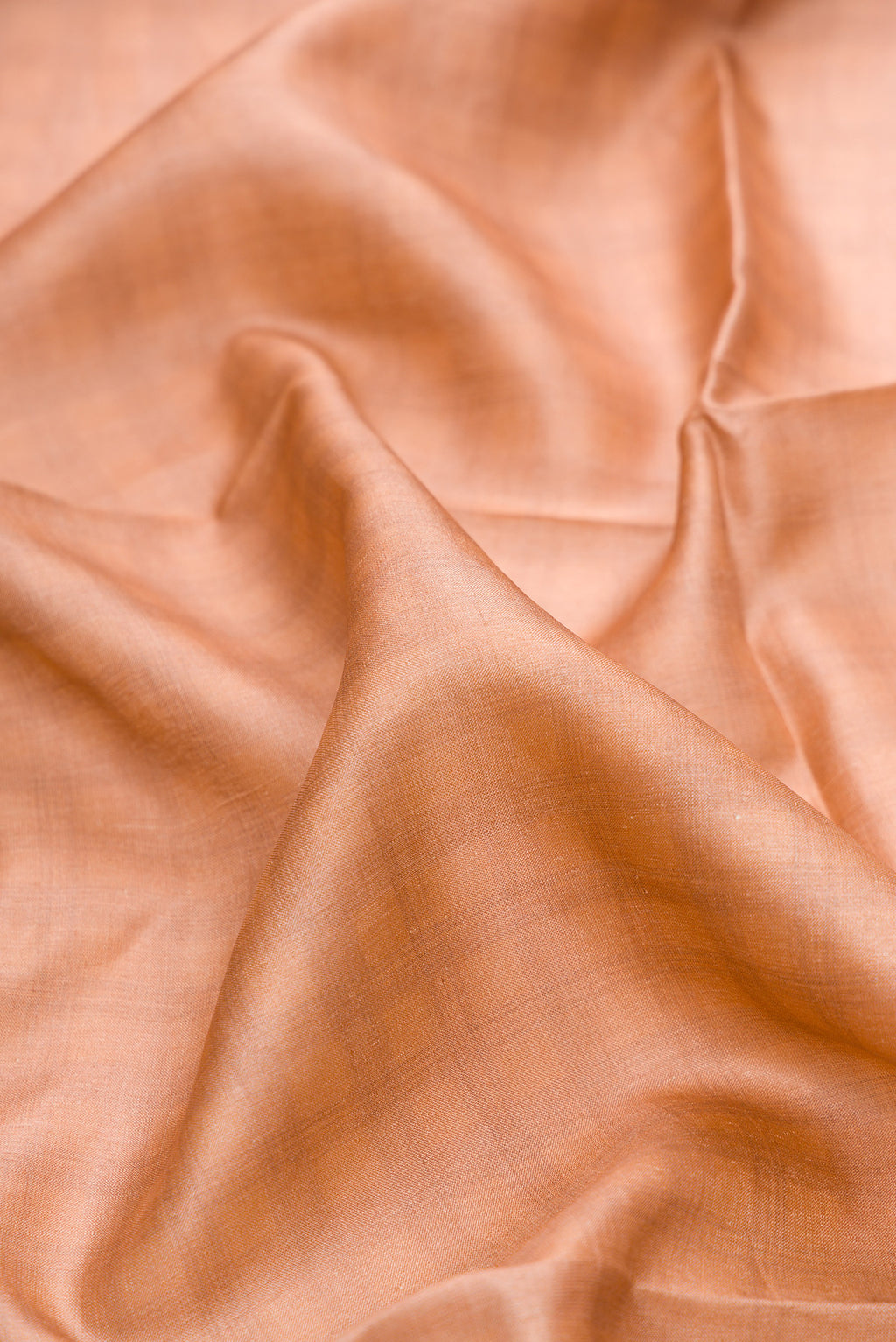 Close up of Beige Tussar Silk Saree with Checked design on the body and Embroidery Border.  displaying folds