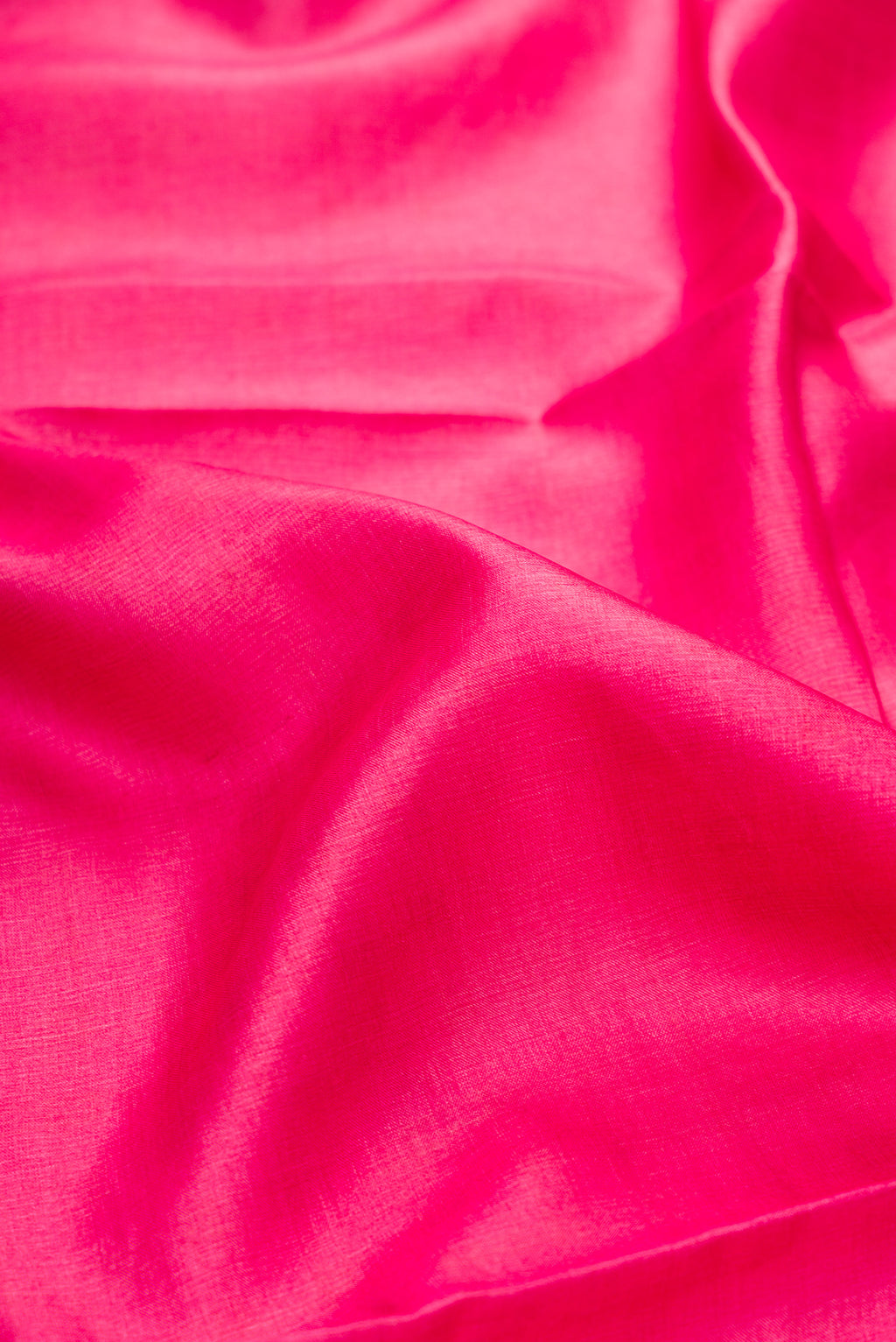 Close up of Pink Tussar Silk Saree with Plain Body and Embroidery Border.  displaying folds