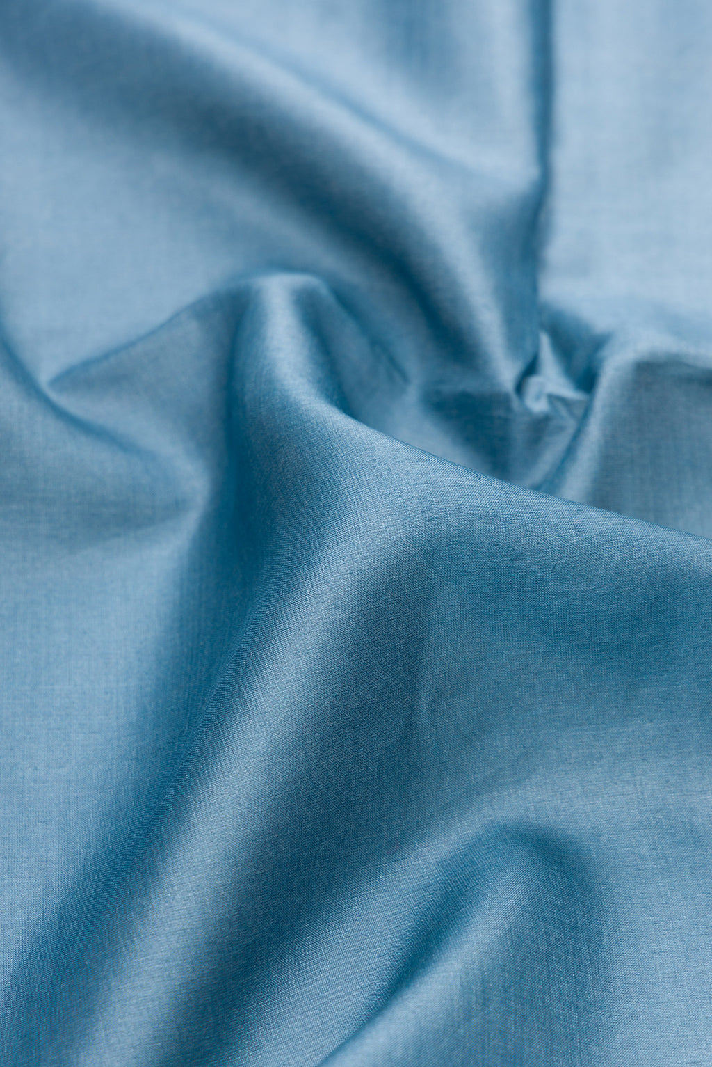 Close up of Blue Grey Tussar Silk Saree with Plain Body and Fancy Border.  displaying folds