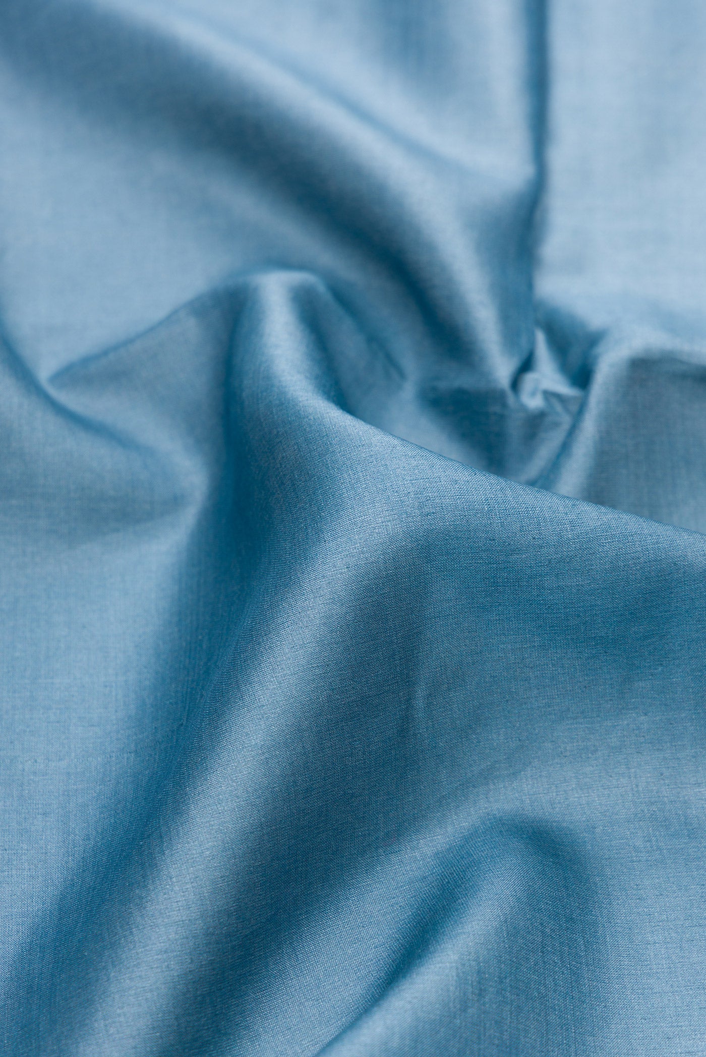 Close up of Blue Grey Tussar Silk Saree with Plain Body and Fancy Border.  displaying folds