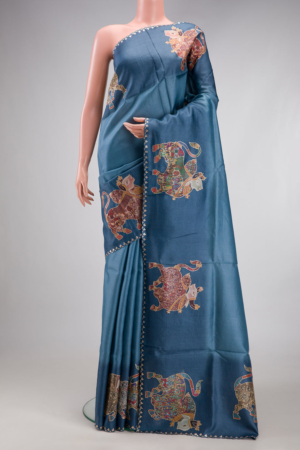 Blue Grey Tussar Silk Saree with Plain Body and Fancy Border.  displayed on a mannequin