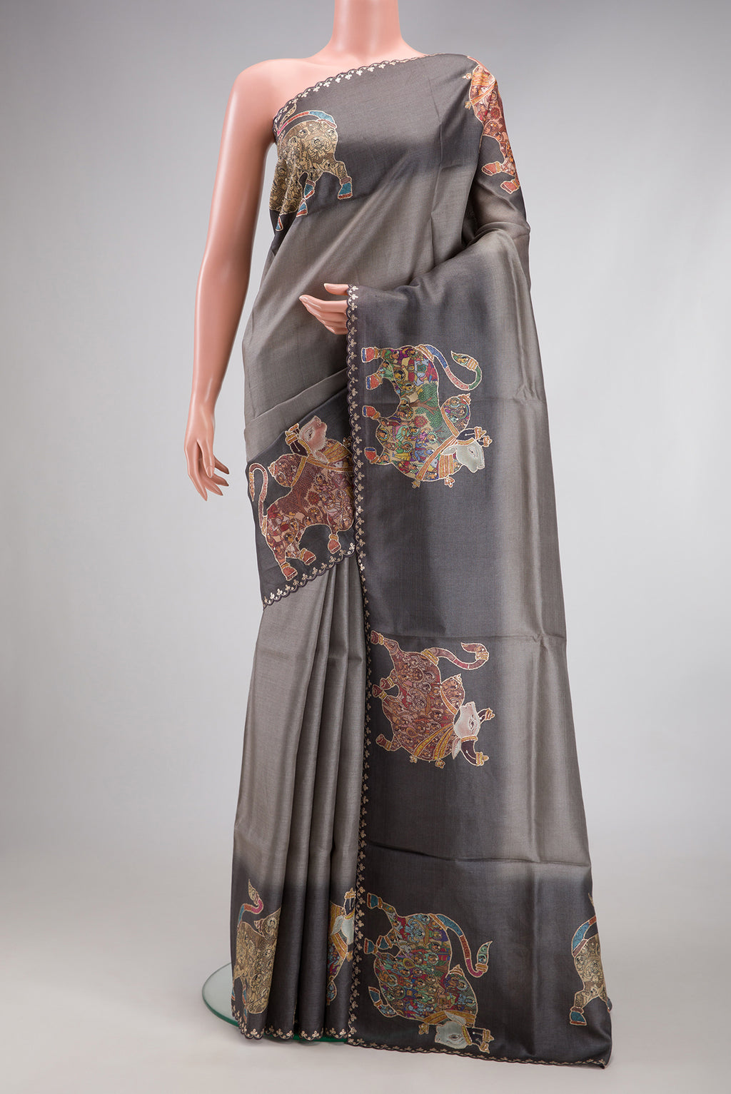 Grey Tussar Silk Saree with Plain Body and Embroidery Border.  displayed on a mannequin