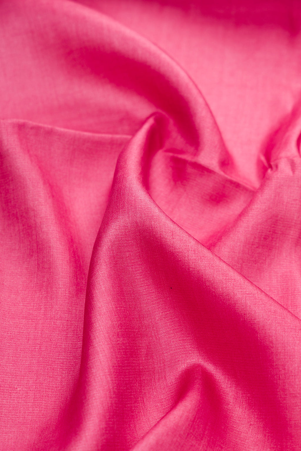 Close up of Pink Tussar Silk Saree with Embroidery on the body and Embroidery Border.  displaying folds
