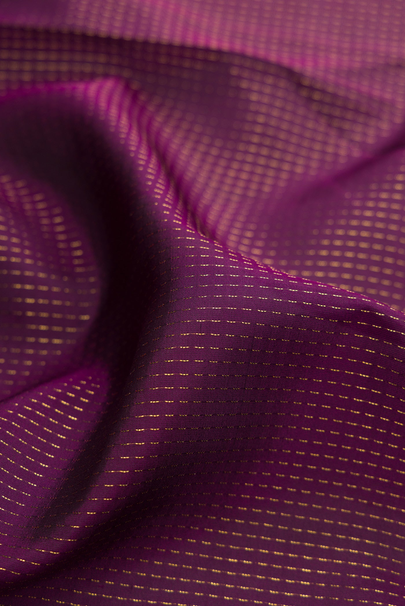 Close up of Burgundy Dual Tone Banarasi Silk Saree with Stripes on the body and Embroidery Border.  displaying folds