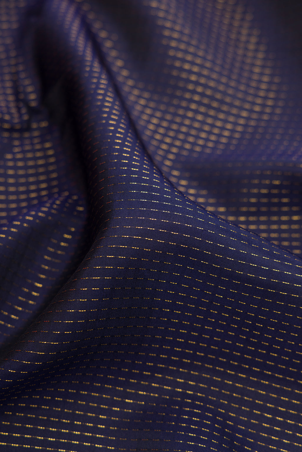 Close up of Navy Blue Dual Tone Banarasi Silk Saree with Stripes on the body and Embroidery Border.  displaying folds