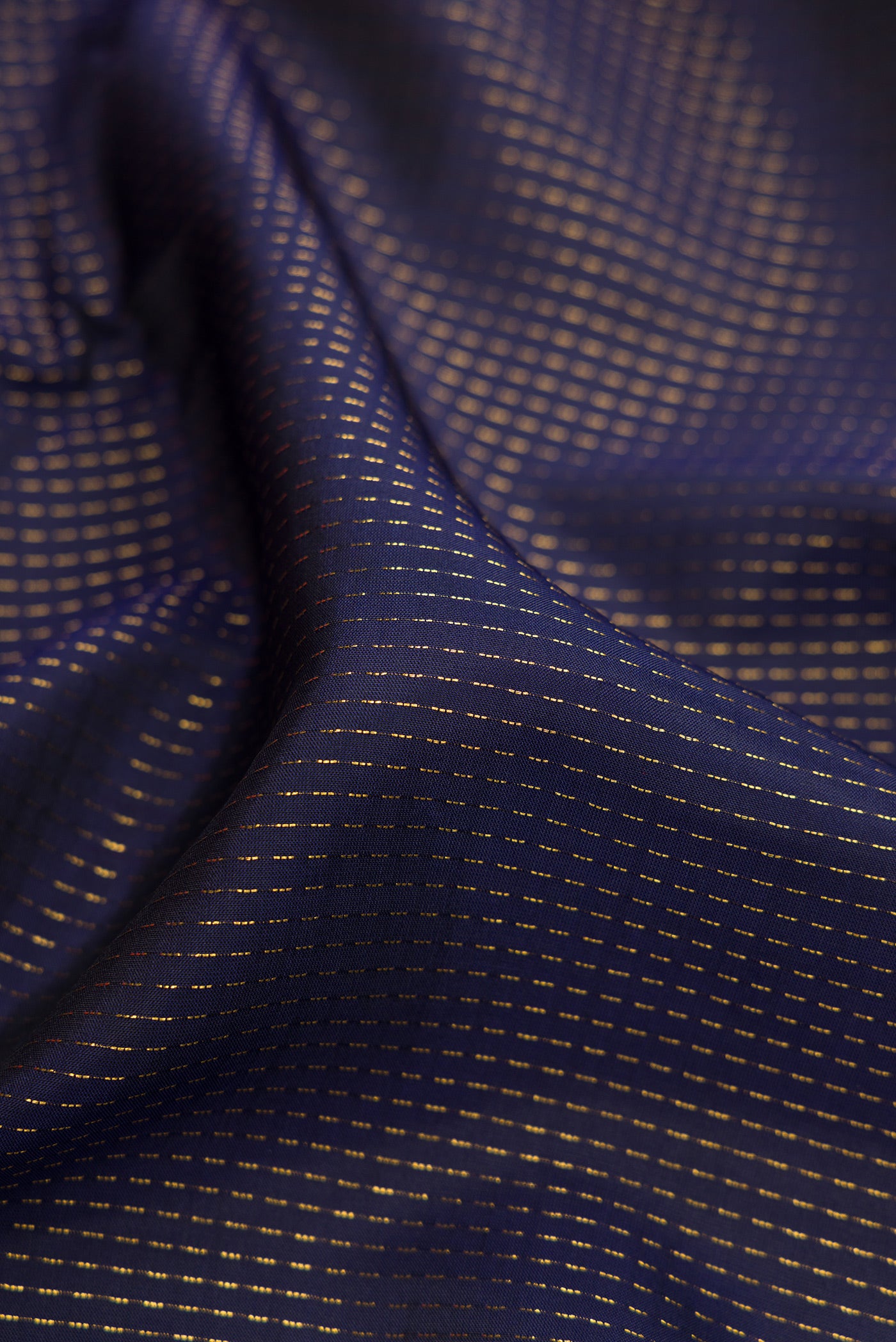 Close up of Navy Blue Dual Tone Banarasi Silk Saree with Stripes on the body and Embroidery Border.  displaying folds