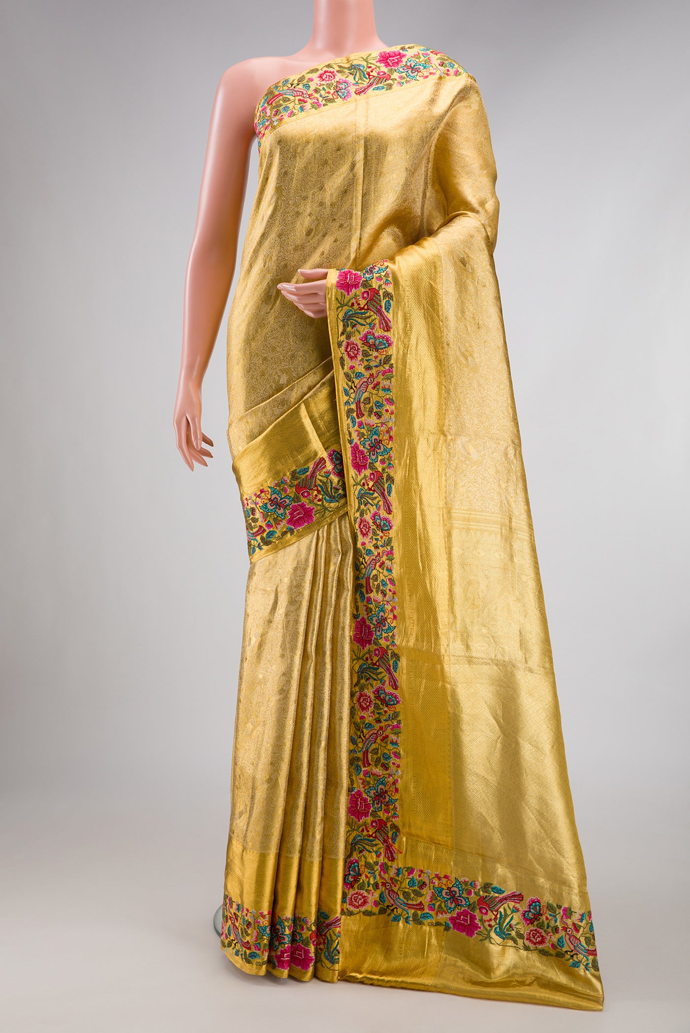Gold Dual Tone Kanjivaram Tissue Silk Saree with Zari Brocade on the body and Embroidery Border.  displayed on a mannequin