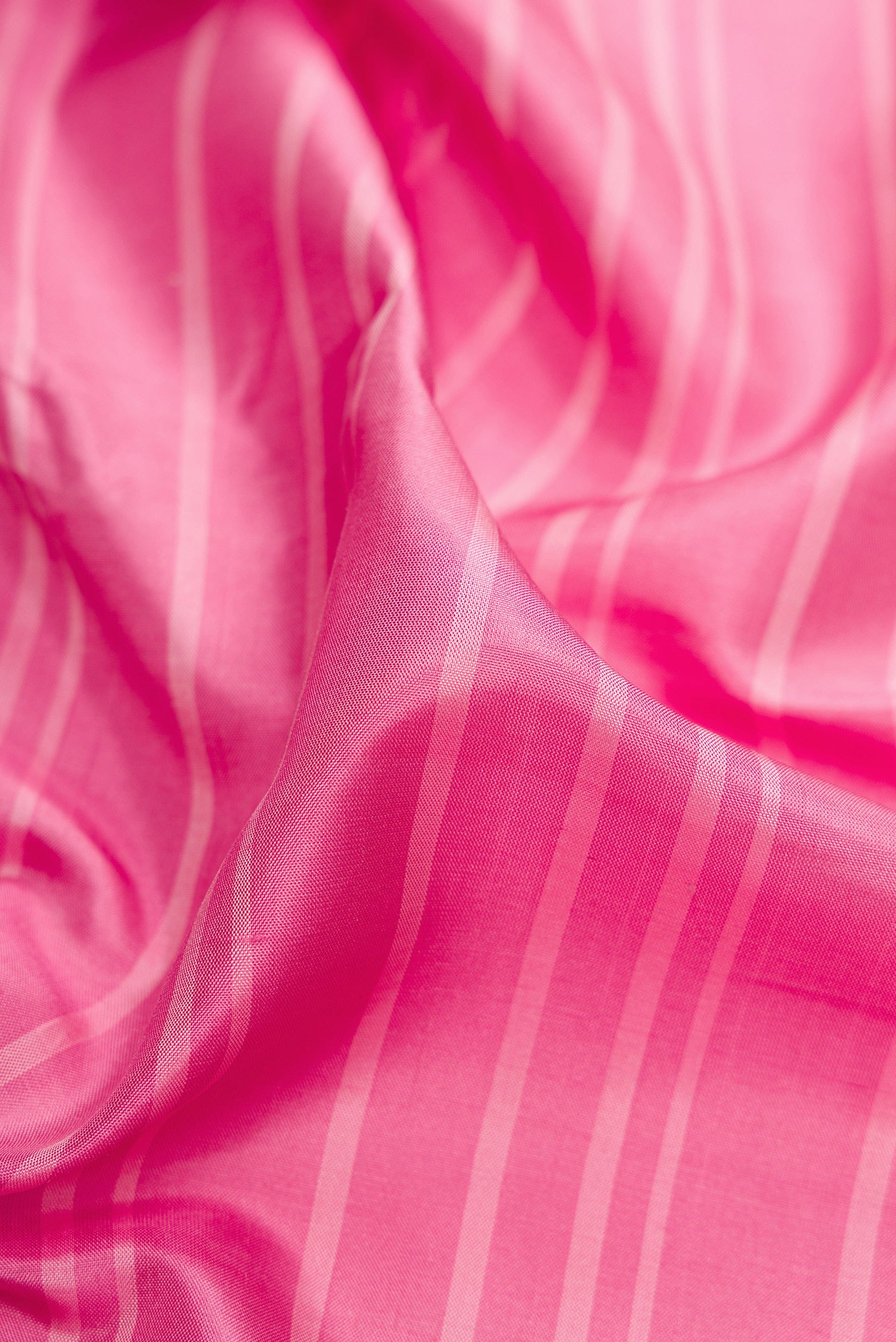 Close up of Pink Dual Tone Banarasi Silk Saree with Stripes on the body and Embroidery Border.  displaying folds