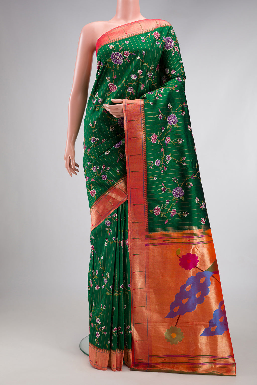 Green Paithani Silk Saree with Embroidery on the body and Paithani Border.  displayed on a mannequin