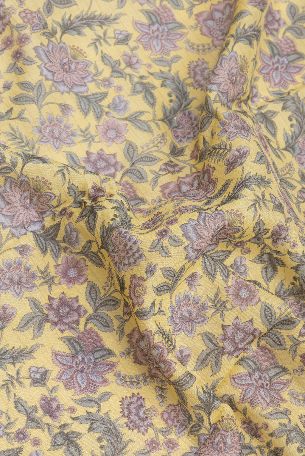 Close up of Yellow Tussar Silk Saree with Printed design on the body and Zari And Thread Border.  displaying folds