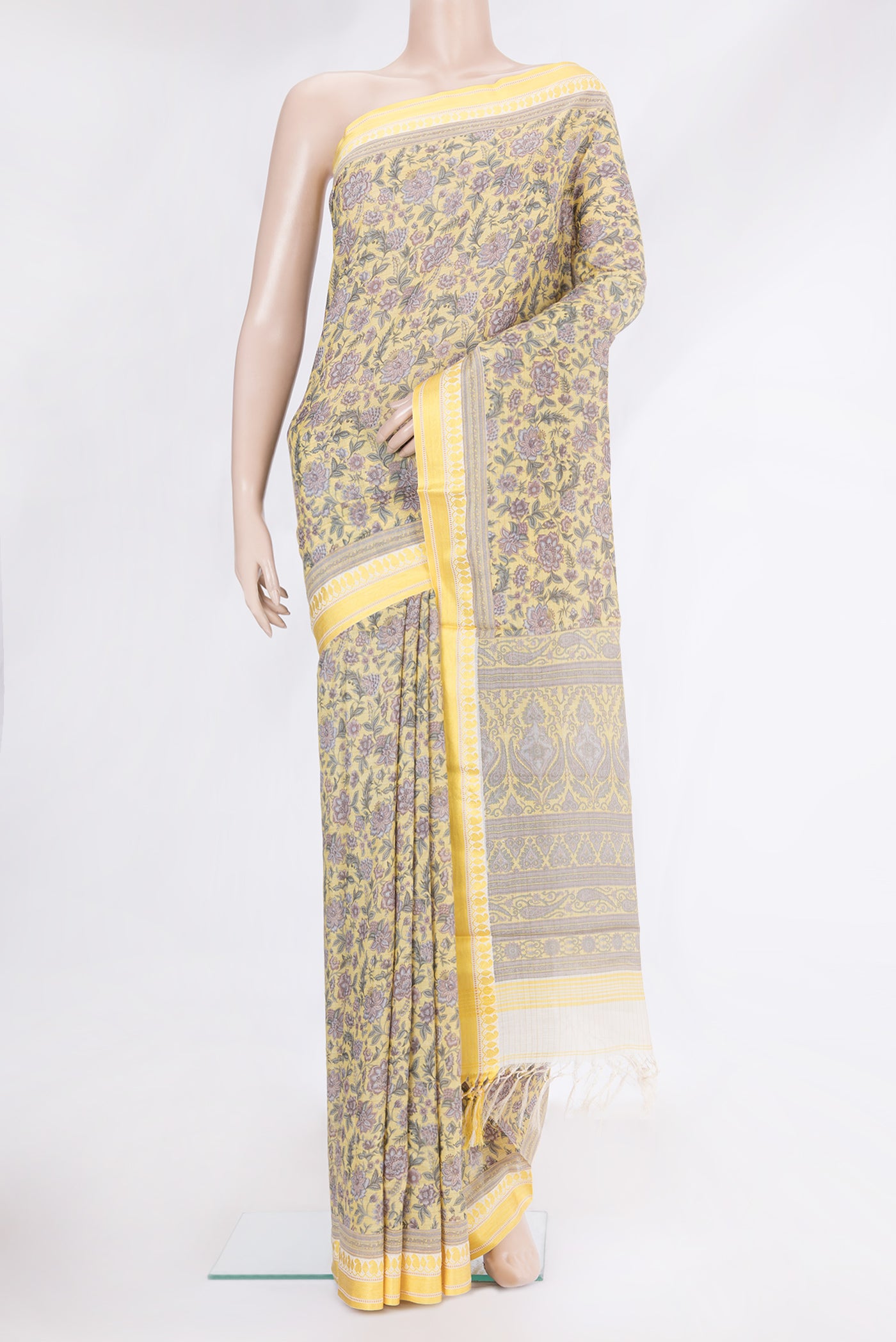 Yellow Tussar Silk Saree with Printed design on the body and Zari And Thread Border.  displayed on a mannequin