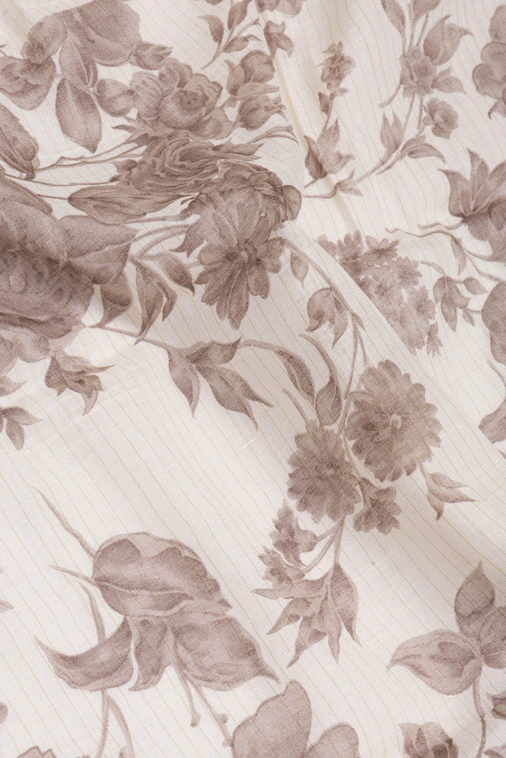 Close up of Off White Tussar Silk Saree with Printed design on the body and Zari And Thread Border.  displaying folds