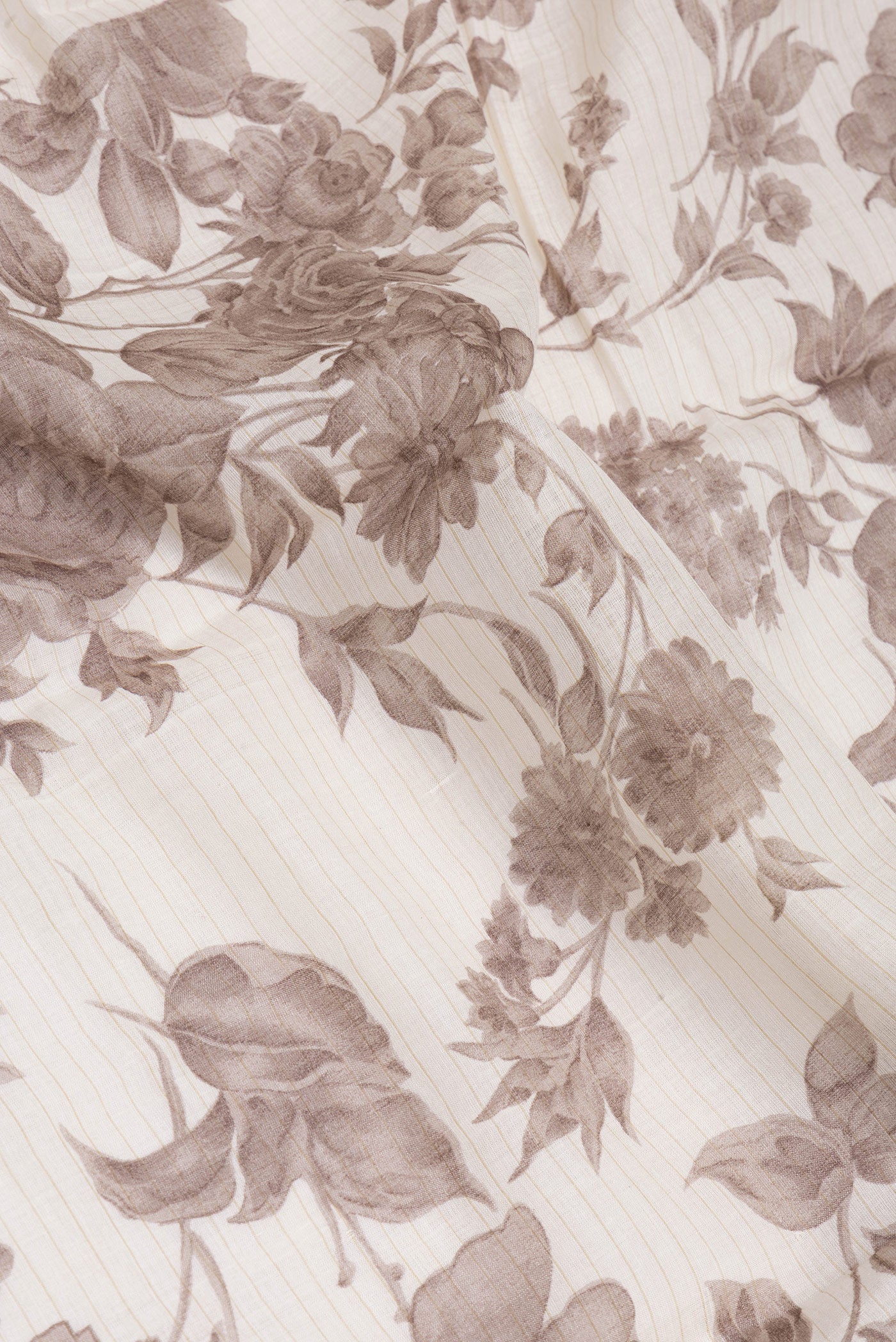 Close up of Off White Tussar Silk Saree with Printed design on the body and Zari And Thread Border.  displaying folds