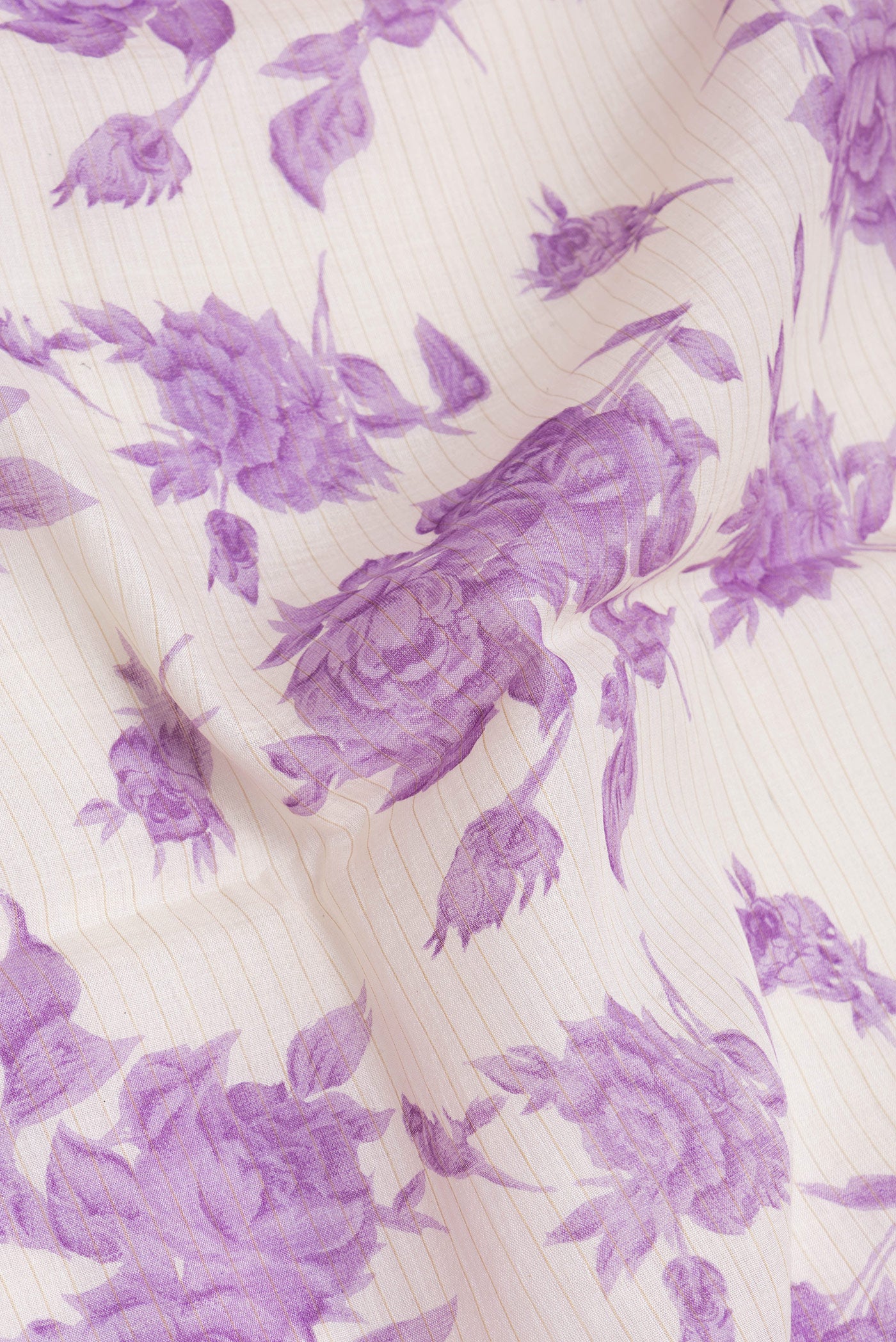 Close up of Cream Tussar Silk Saree with Floral Print on the body and Zari And Thread Border.  displaying folds