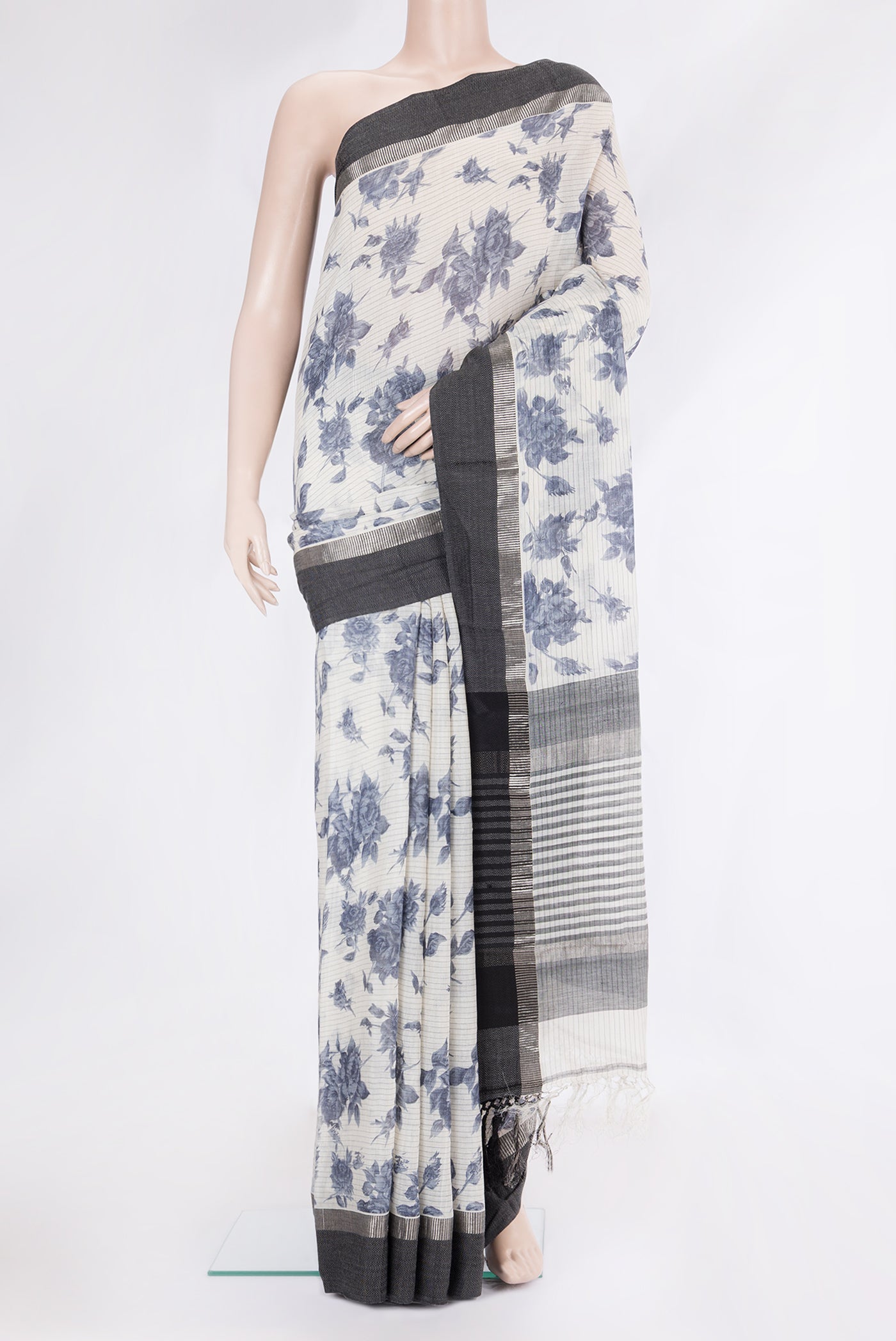 Cream Tussar Silk Saree with Floral Print on the body and Zari And Thread Border.  displayed on a mannequin