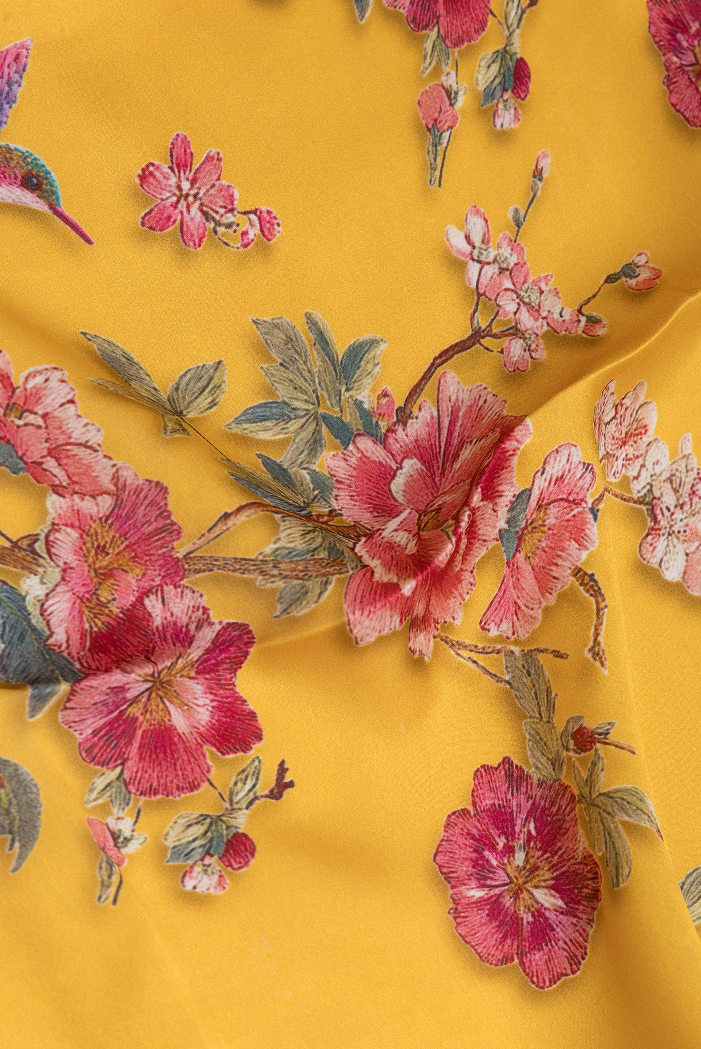 Close up of Yellow Crepe Saree with Floral Print on the body and Without Border.  displaying folds