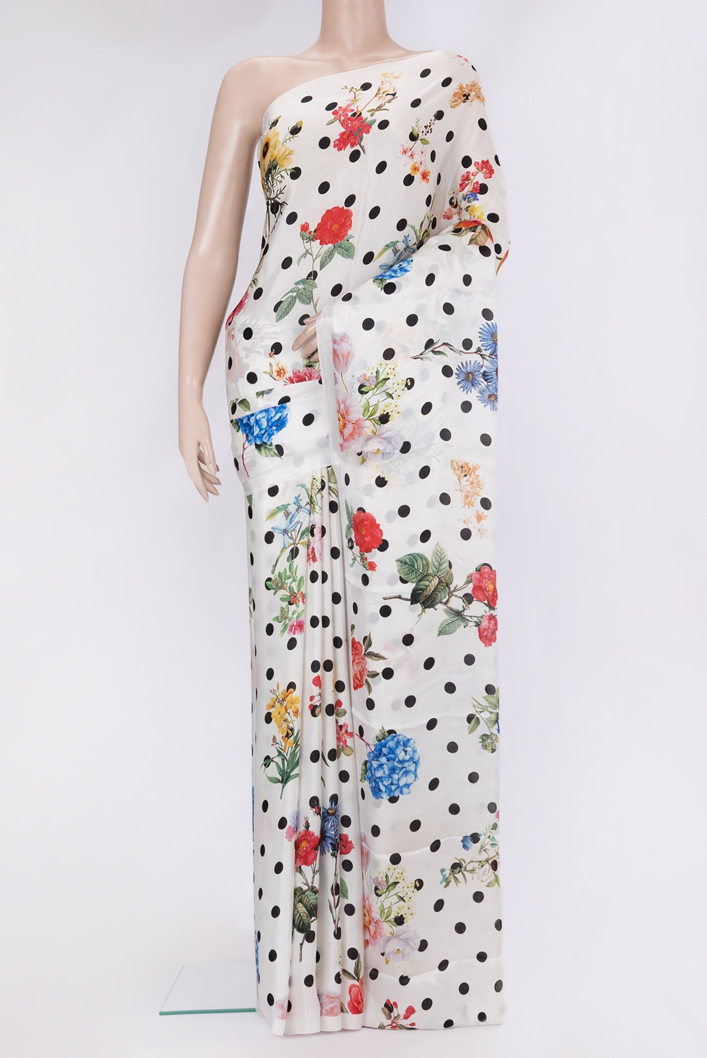 White Crepe Saree with Polka Dots on the body and Without Border.  displayed on a mannequin