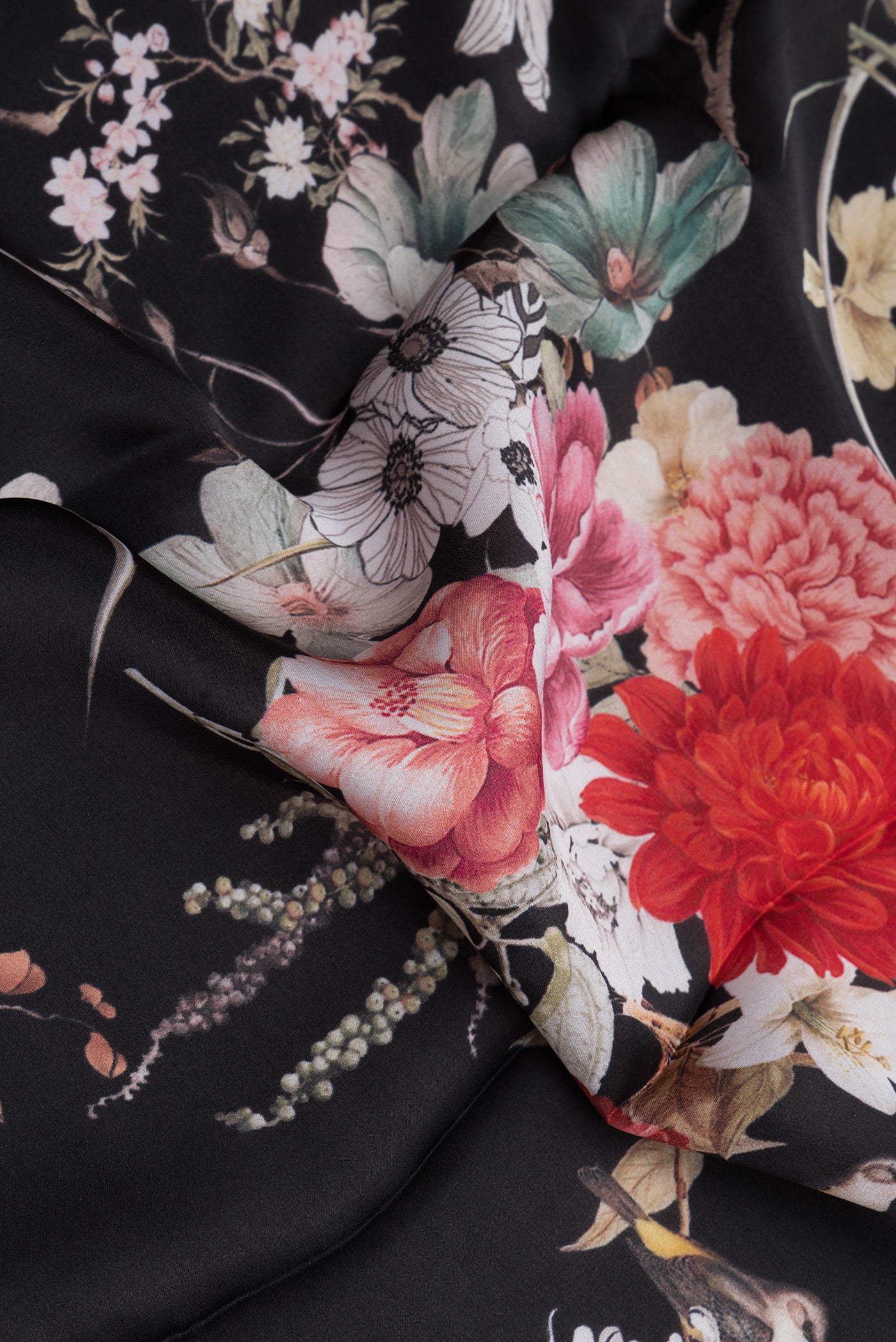 Close up of Black Crepe Saree with Printed design on the body and Without Border.  displaying folds