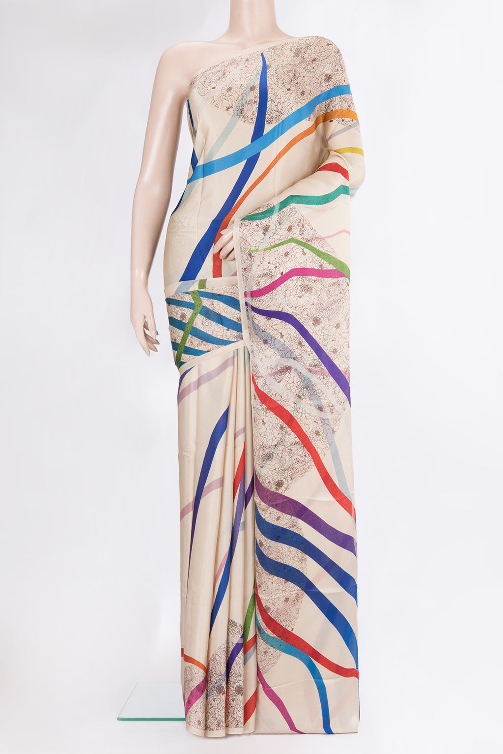 Beige Crepe Saree with Printed design on the body and Without Border.  displayed on a mannequin