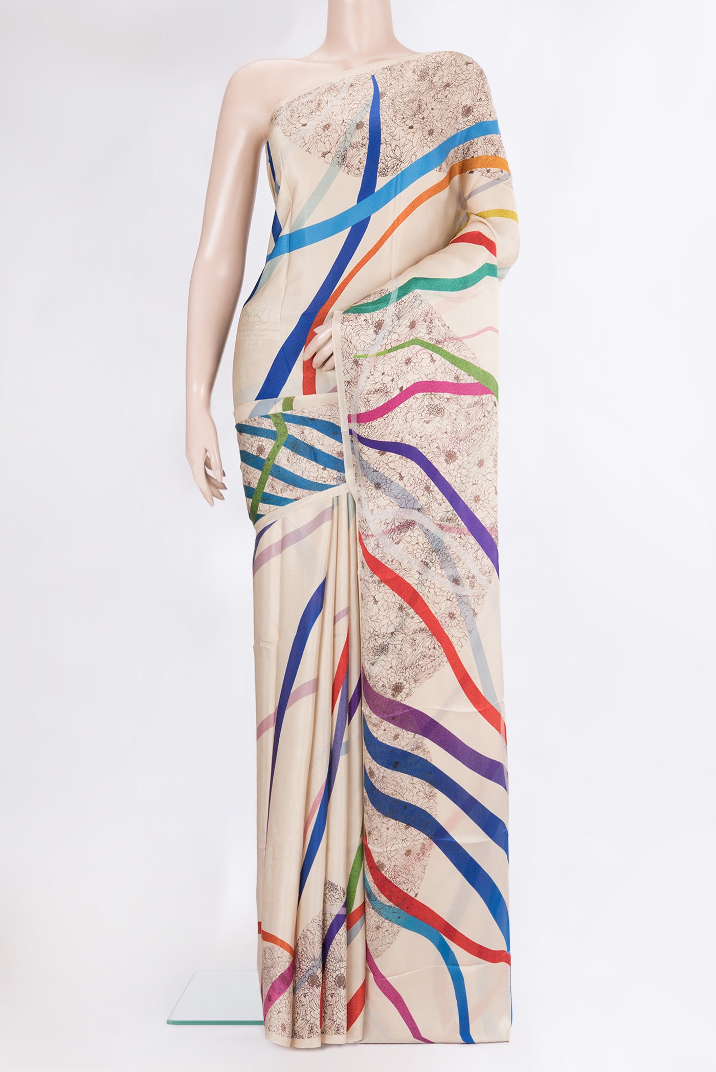 Beige Crepe Saree with Printed design on the body and Without Border.  displayed on a mannequin