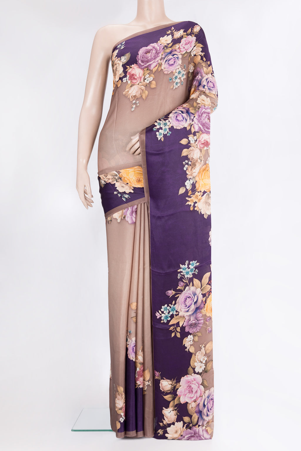 Brown Crepe Saree with Printed design on the body and Printed Border.  displayed on a mannequin
