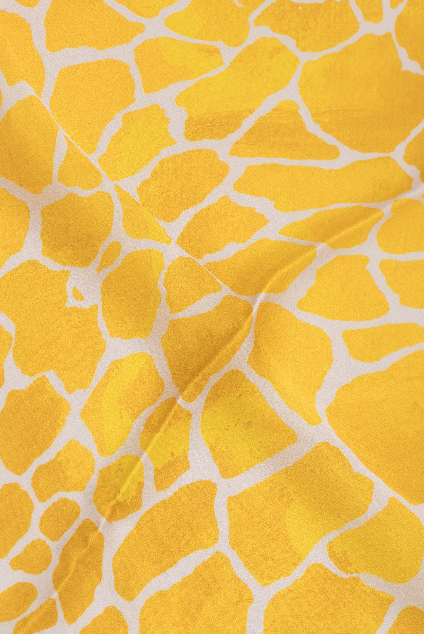 Close up of Yellow Crepe Saree with Printed design on the body and Without Border.  displaying folds