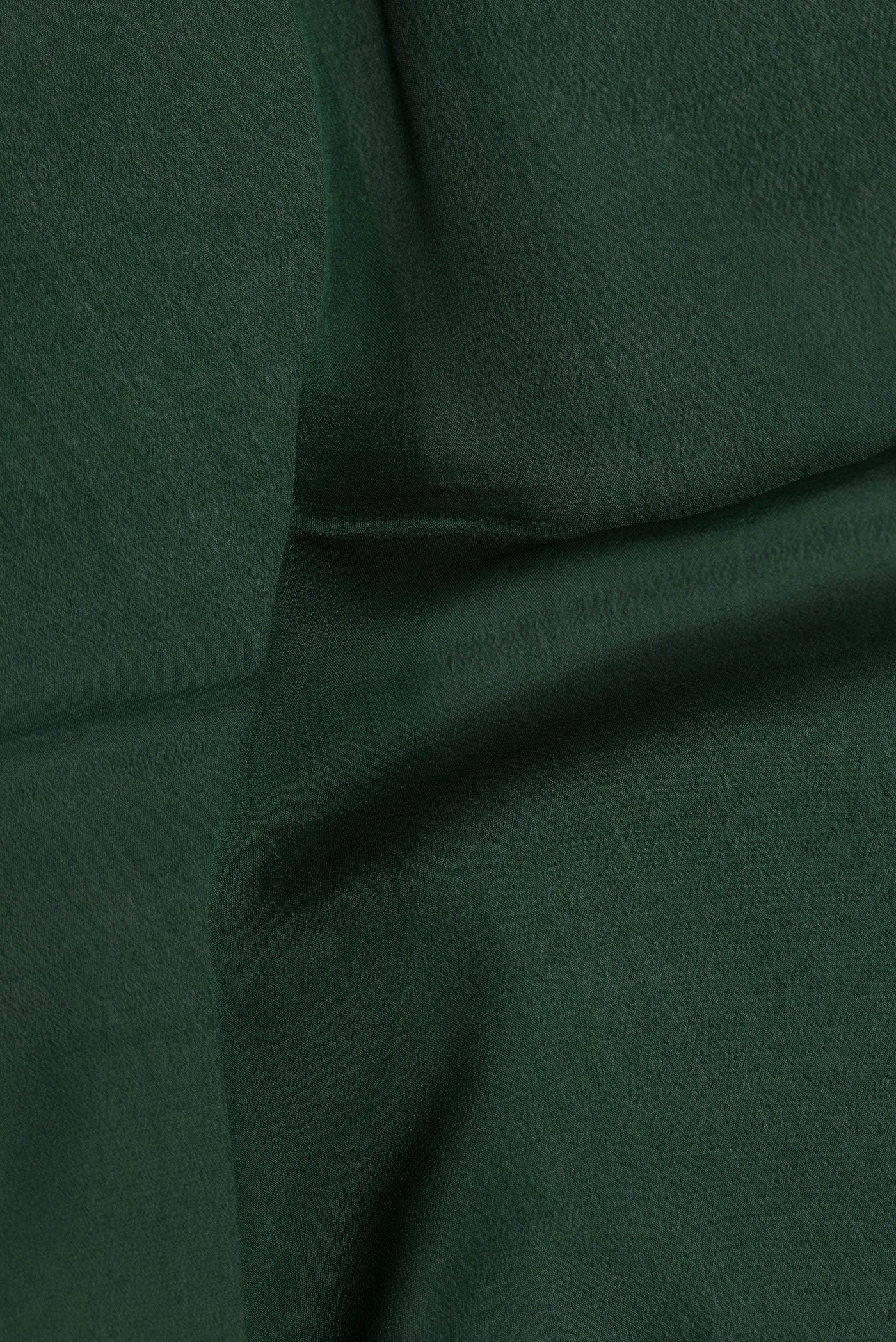Close up of Bottle Green Mysore Silk Saree with Plain Body and Fancy Border.  displaying folds