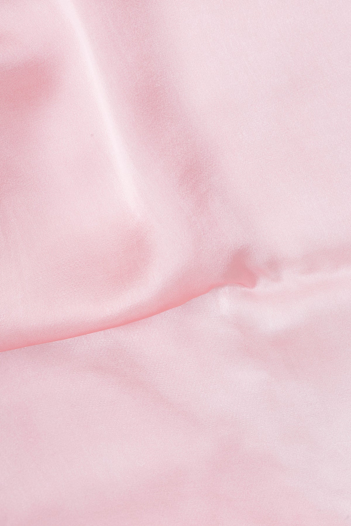 Close up of Rose pink Crepe Saree with Plain Body and Without Border.  displaying folds