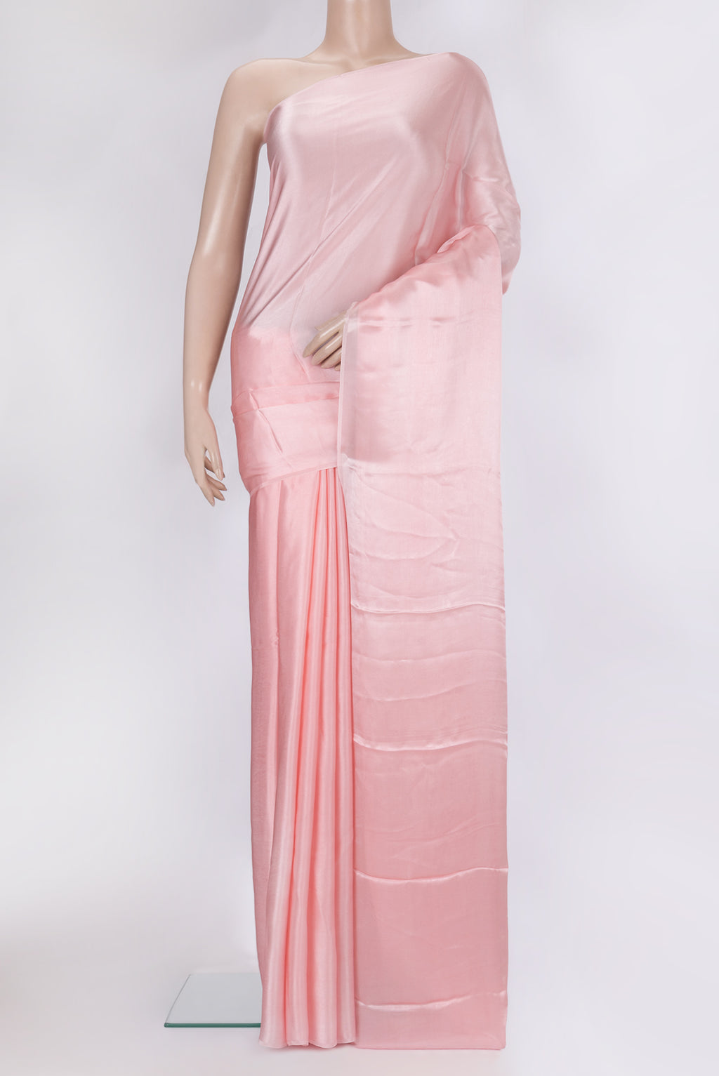 Rose pink Crepe Saree with Plain Body and Without Border.  displayed on a mannequin