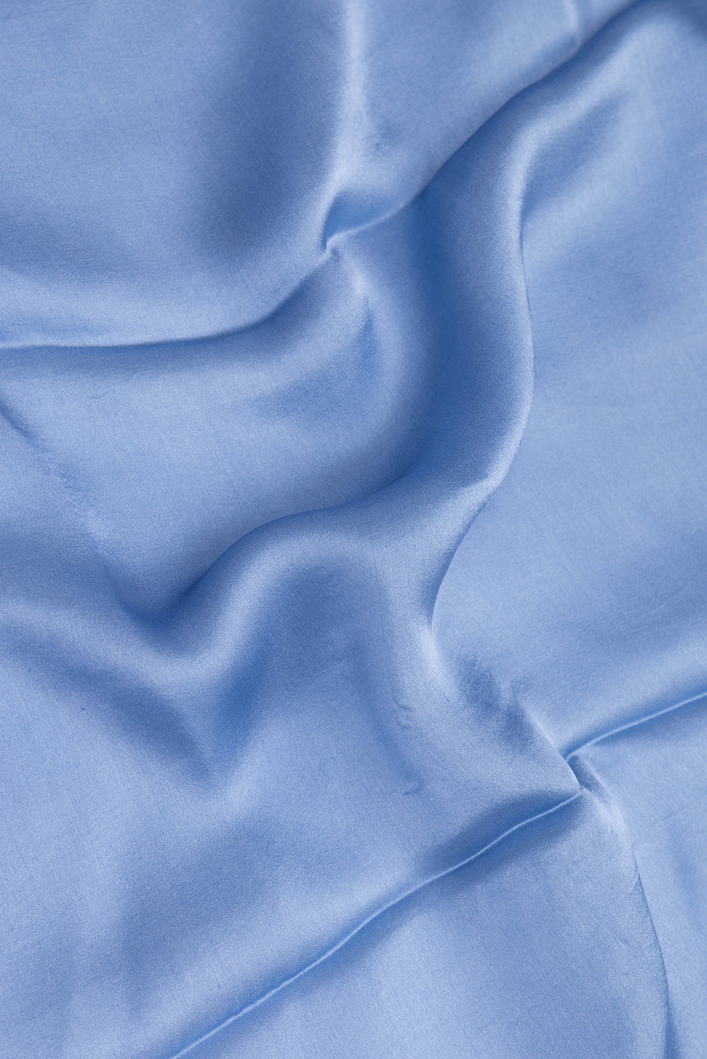 Close up of Maya Blue Crepe Saree with Plain Body and Without Border.  displaying folds