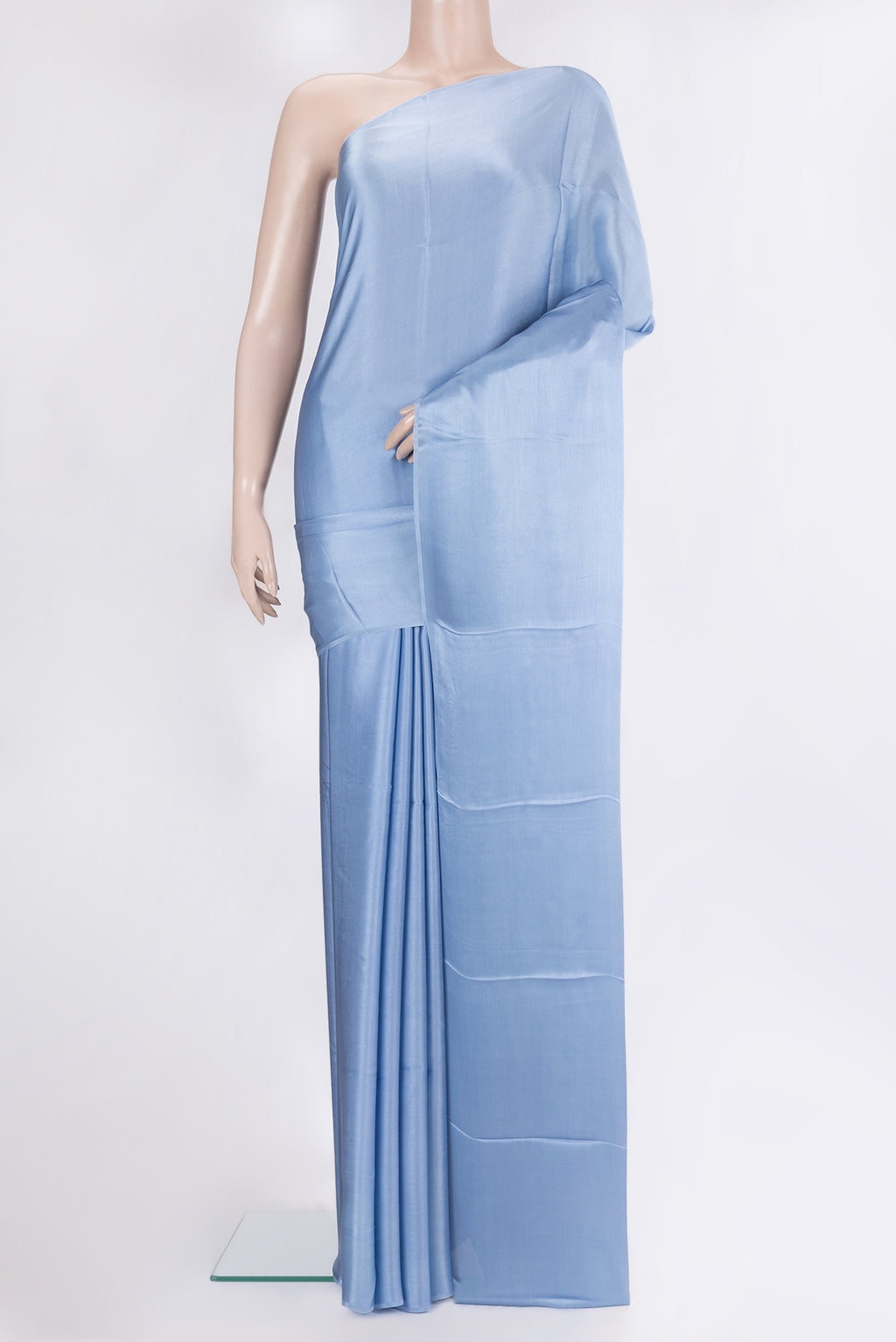 Maya Blue Crepe Saree with Plain Body and Without Border.  displayed on a mannequin
