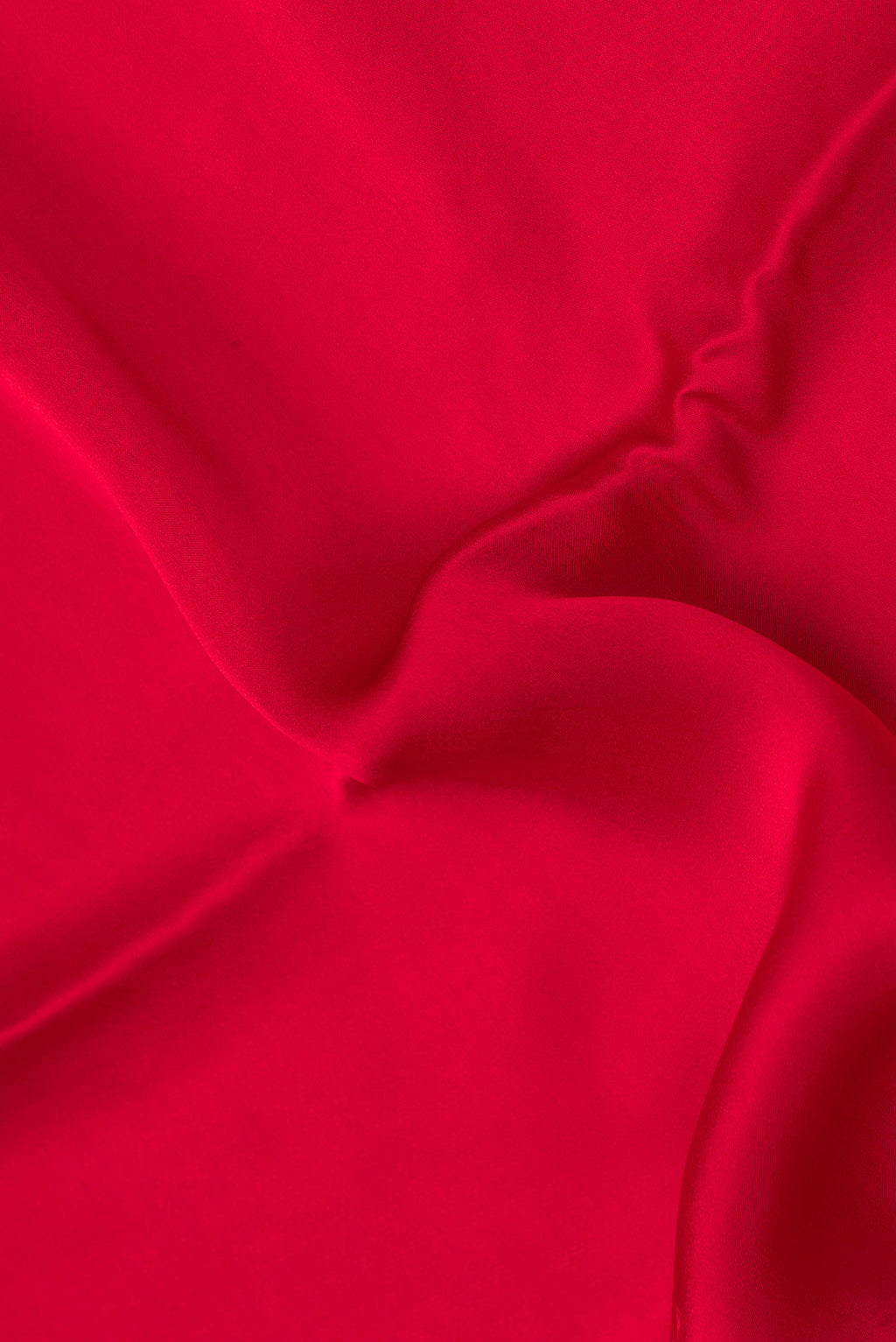 Close up of Red Crepe Saree with Plain Body and Without Border.  displaying folds