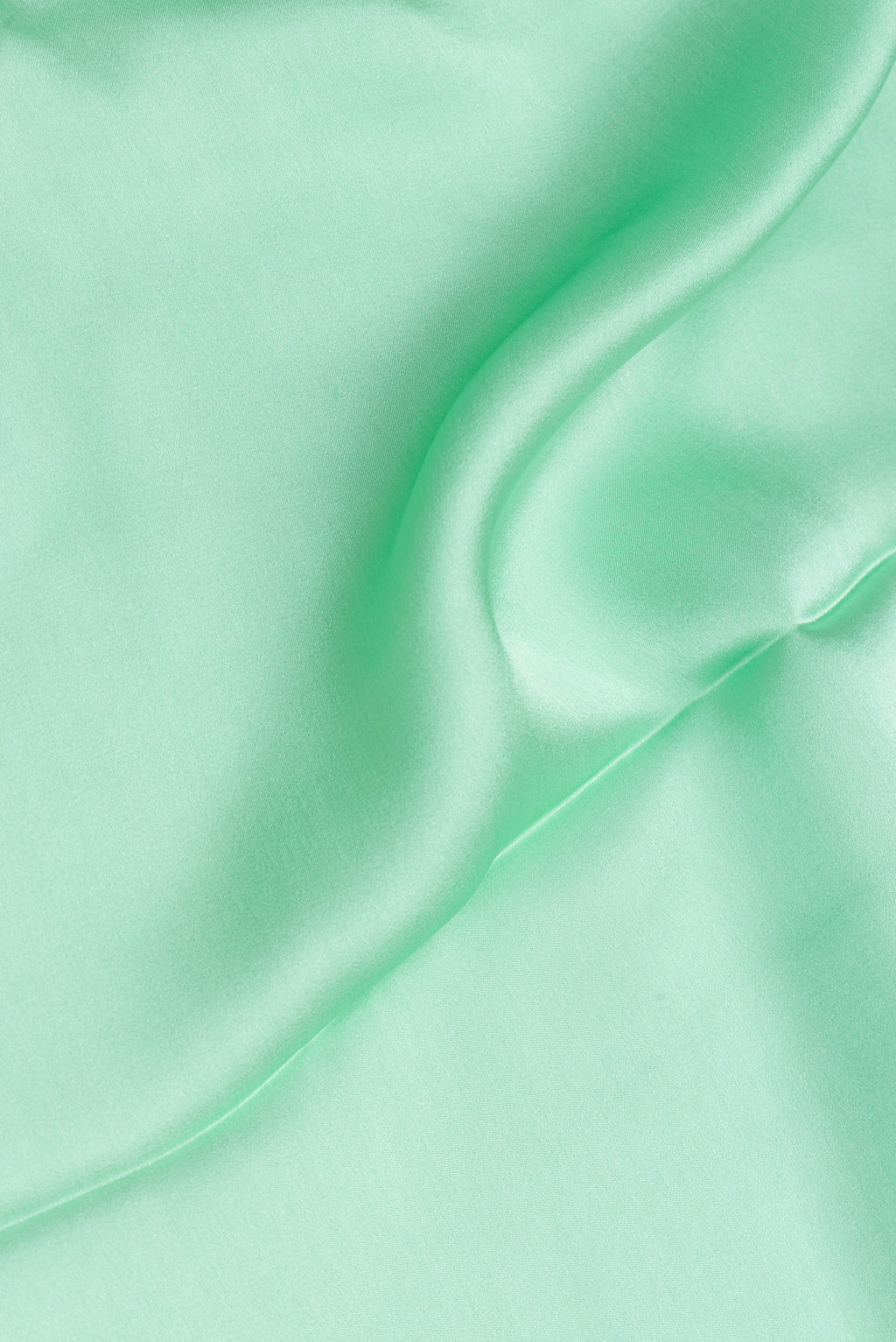Close up of Pista Green Crepe Saree with Plain Body and Without Border.  displaying folds