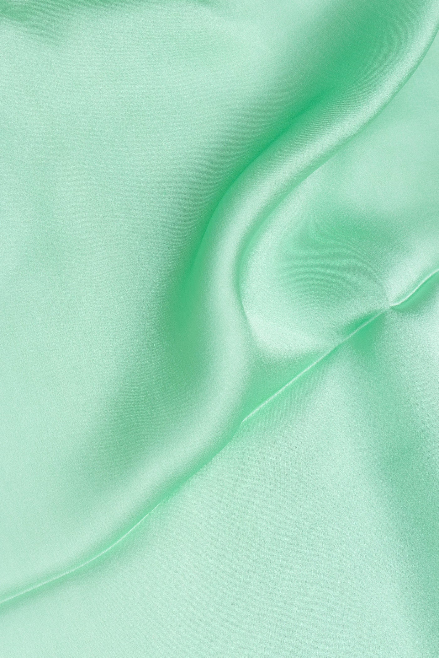 Close up of Pista Green Crepe Saree with Plain Body and Without Border.  displaying folds