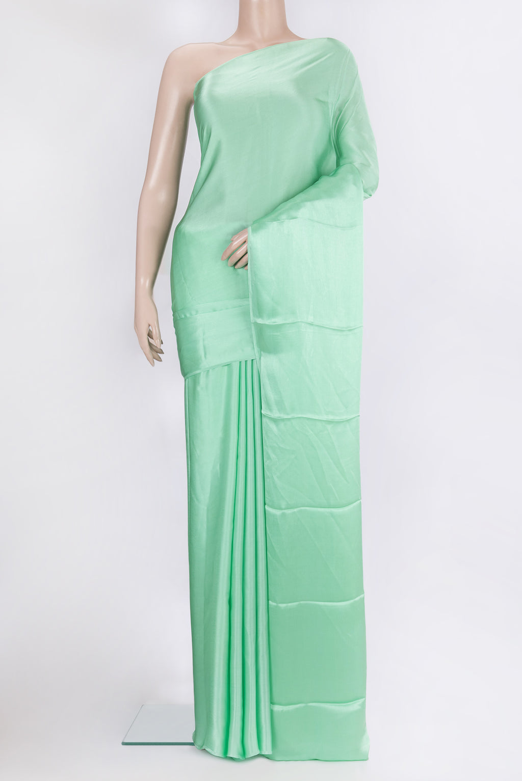 Pista Green Crepe Saree with Plain Body and Without Border.  displayed on a mannequin