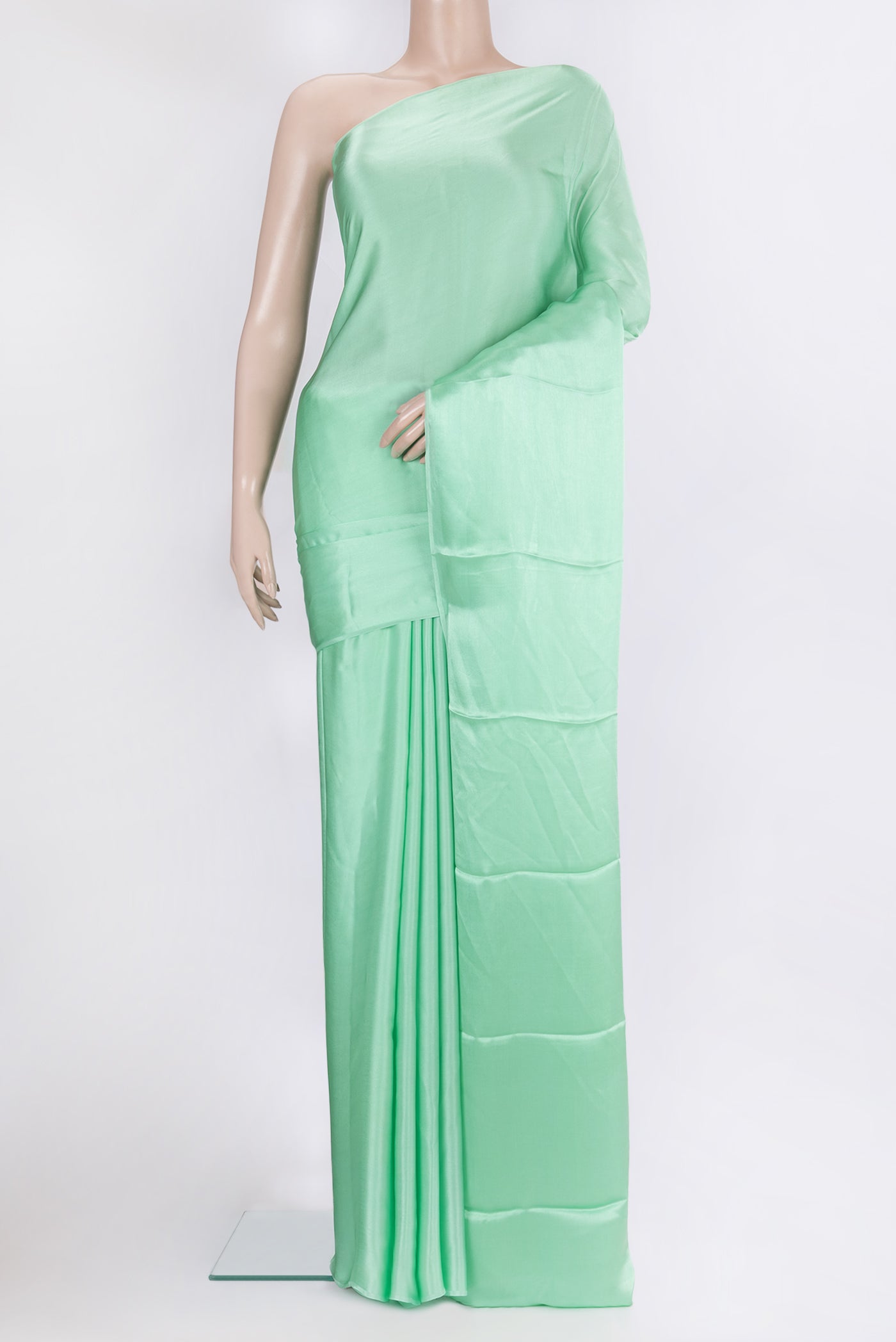 Pista Green Crepe Saree with Plain Body and Without Border.  displayed on a mannequin