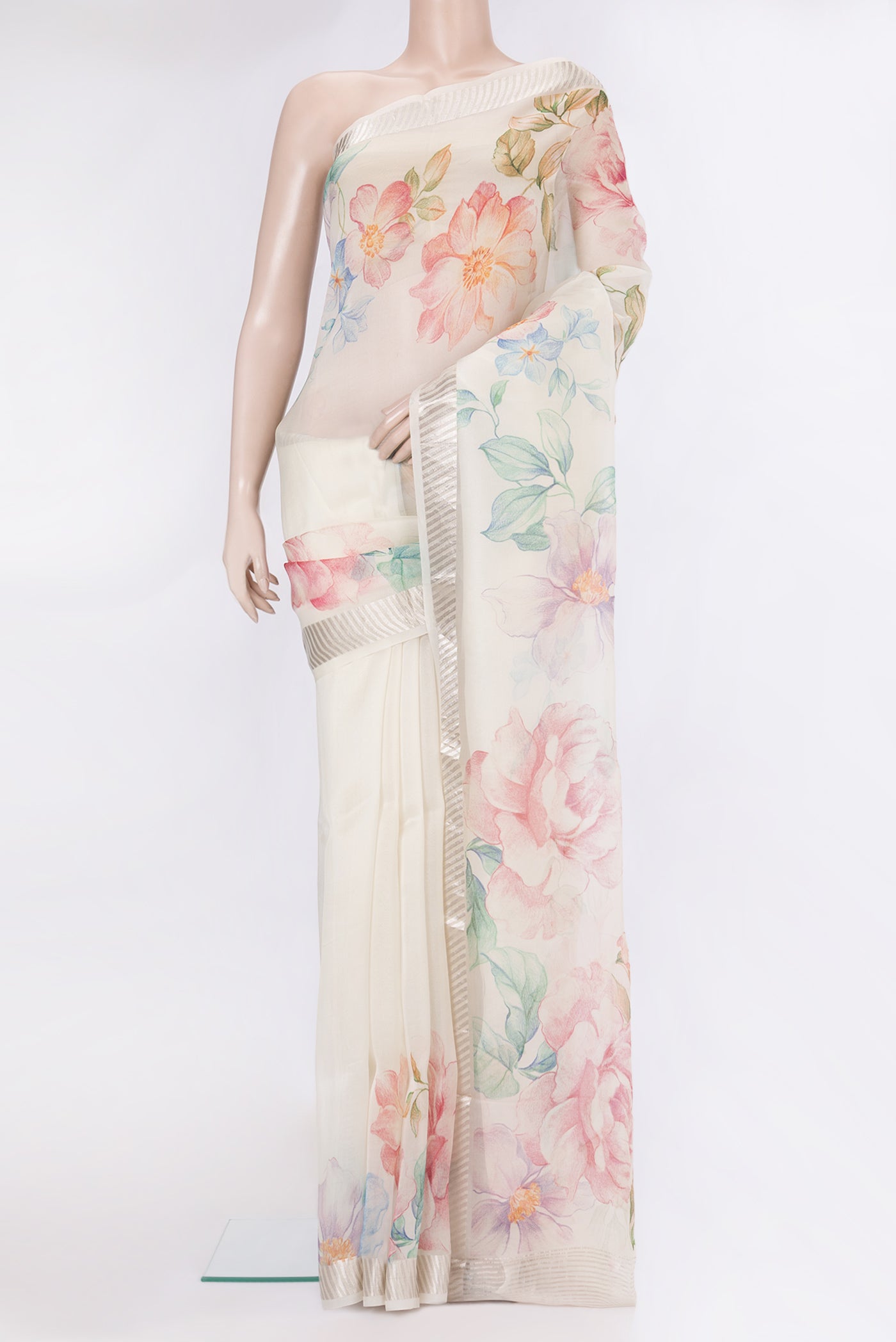 Cream Organza Silk Saree with Floral Print on the body and Zari Border.  displayed on a mannequin