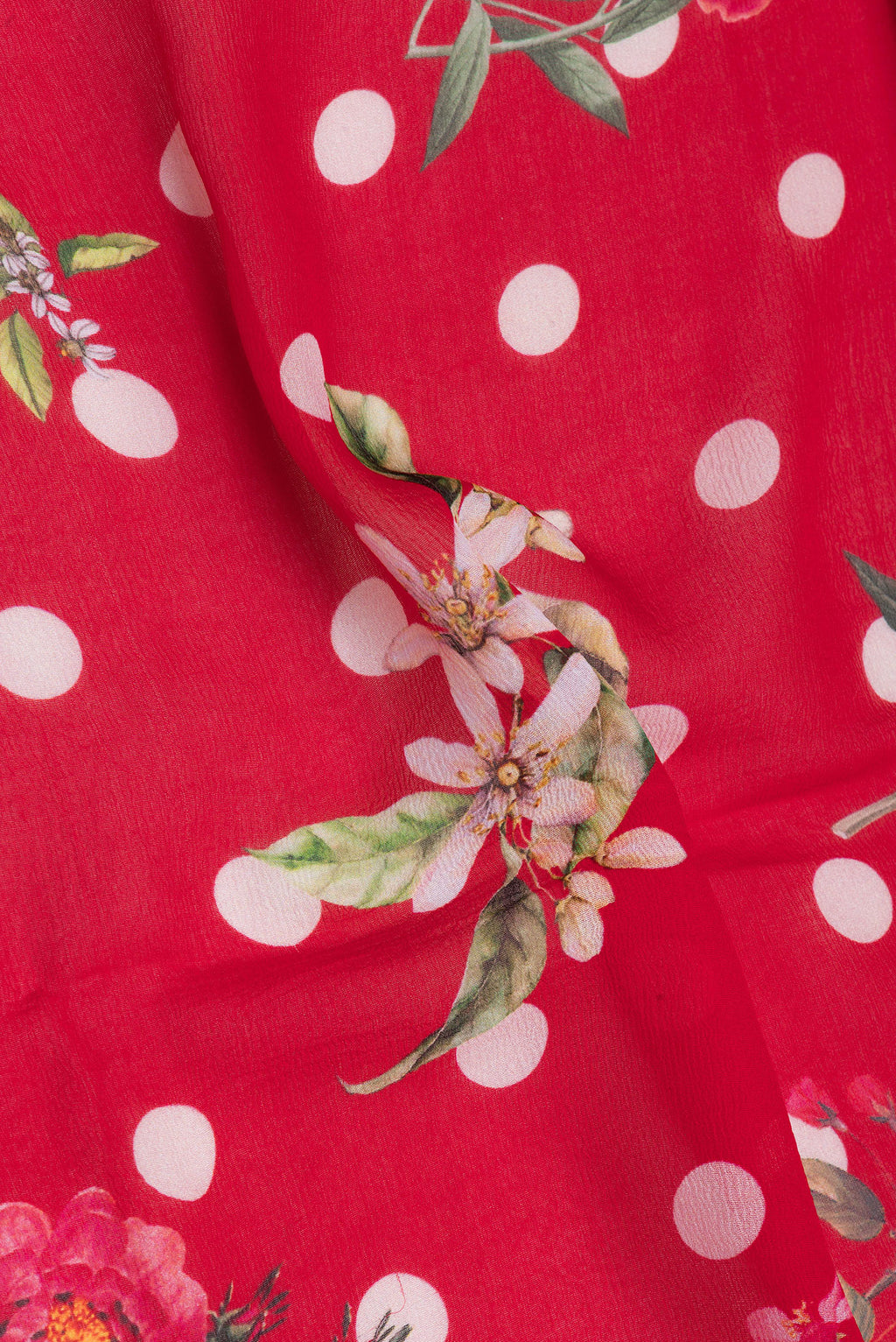Close up of Red Chiffon Saree with Printed design on the body and Without Border.  displaying folds