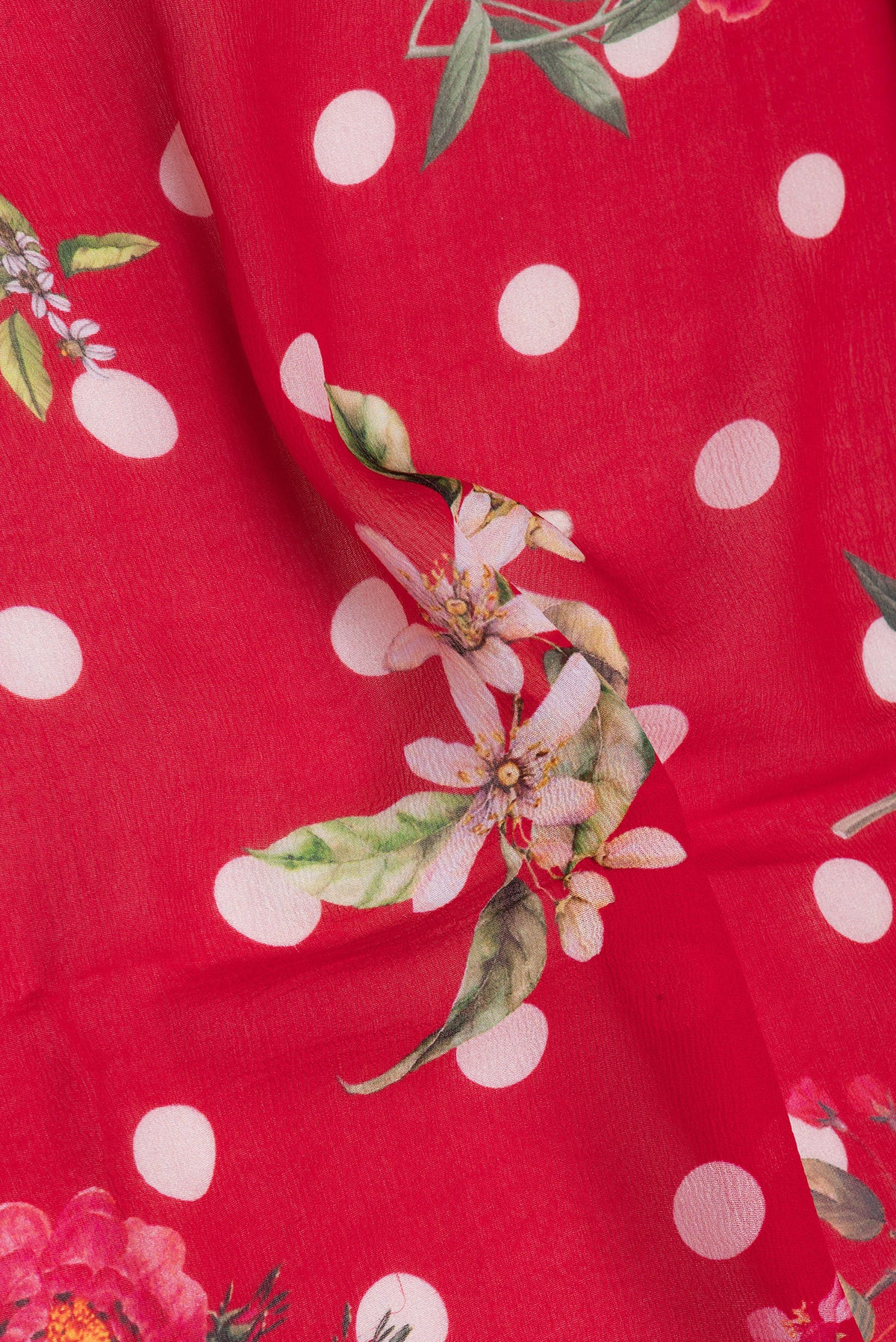 Close up of Red Chiffon Saree with Printed design on the body and Without Border.  displaying folds