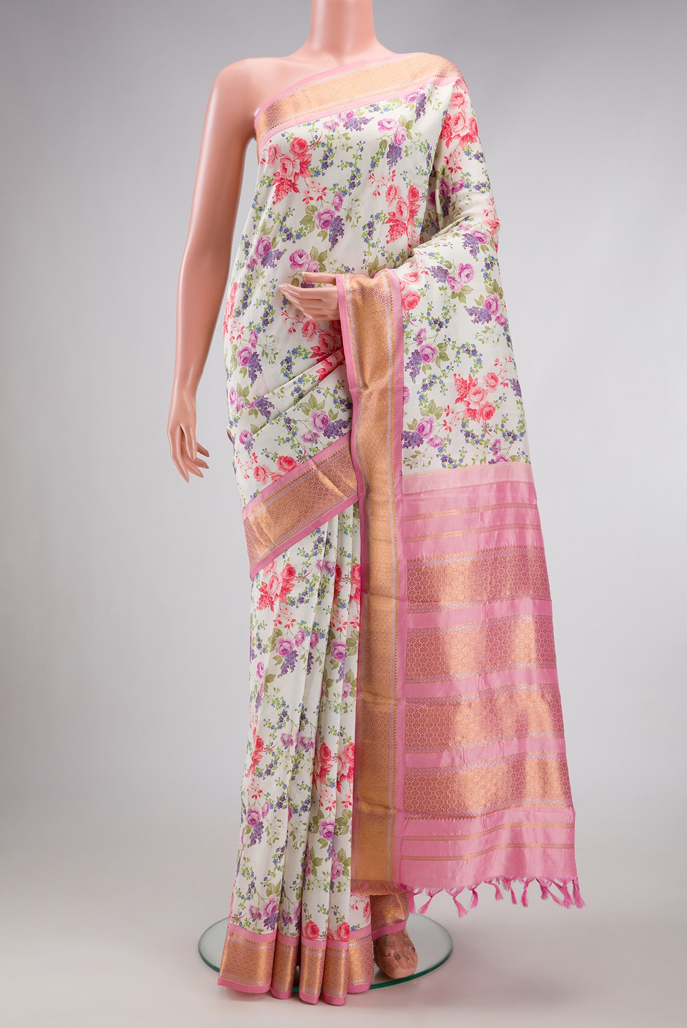 Off White Kanchipuram Silk Saree with Floral Print on the body and Zari Border.  displayed on a mannequin