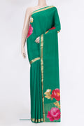 Green Crepe Saree with Plain Body and Zari Border.  displayed on a mannequin