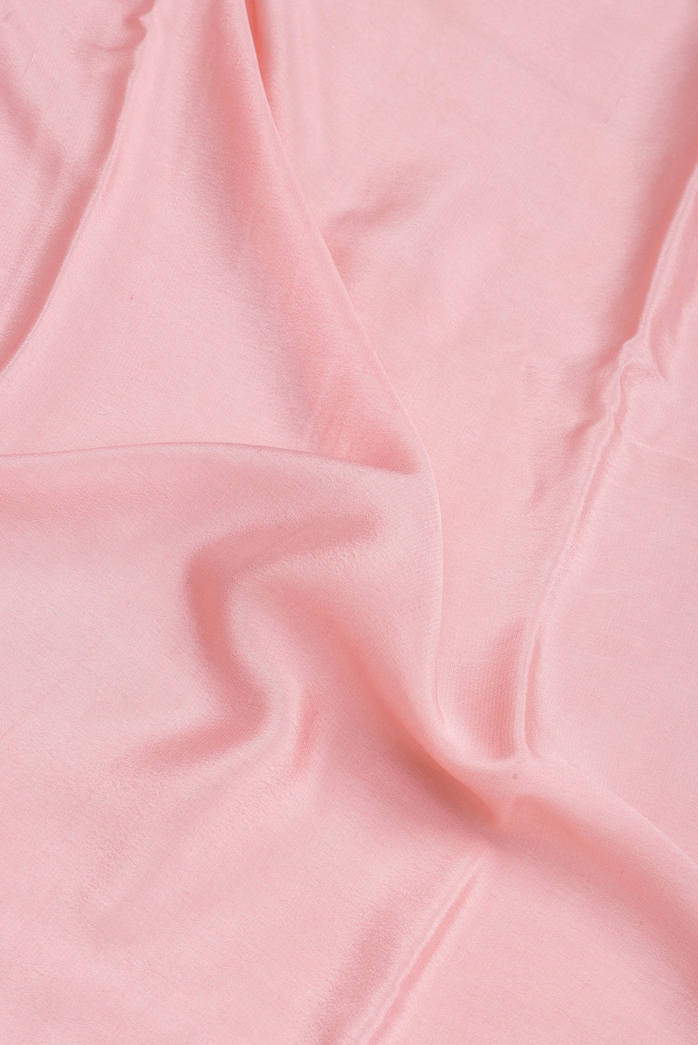 Close up of Rose pink Crepe Saree with Plain Body and Zari Border.  displaying folds